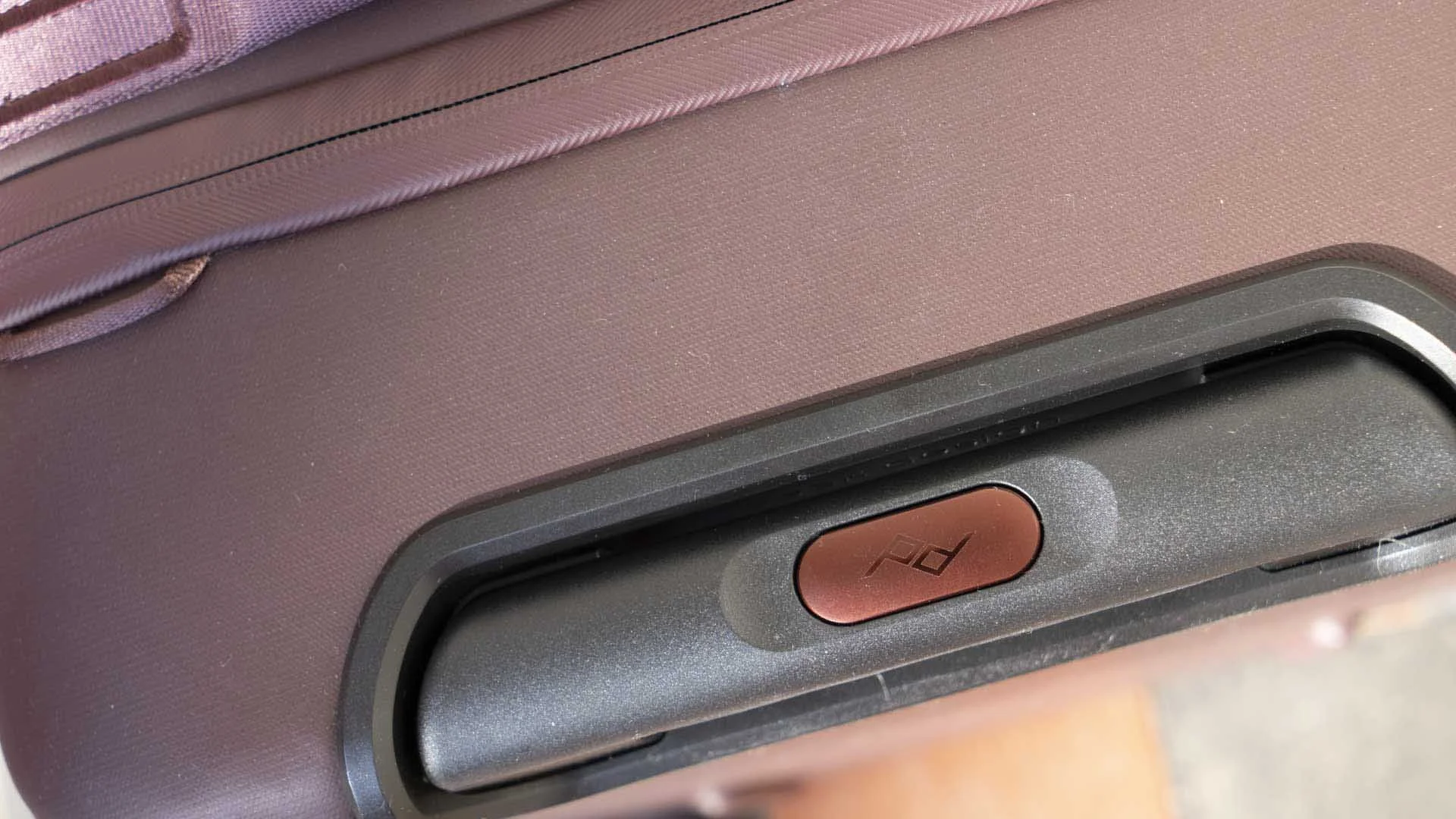  The extendable handle is released with a press of a button. 