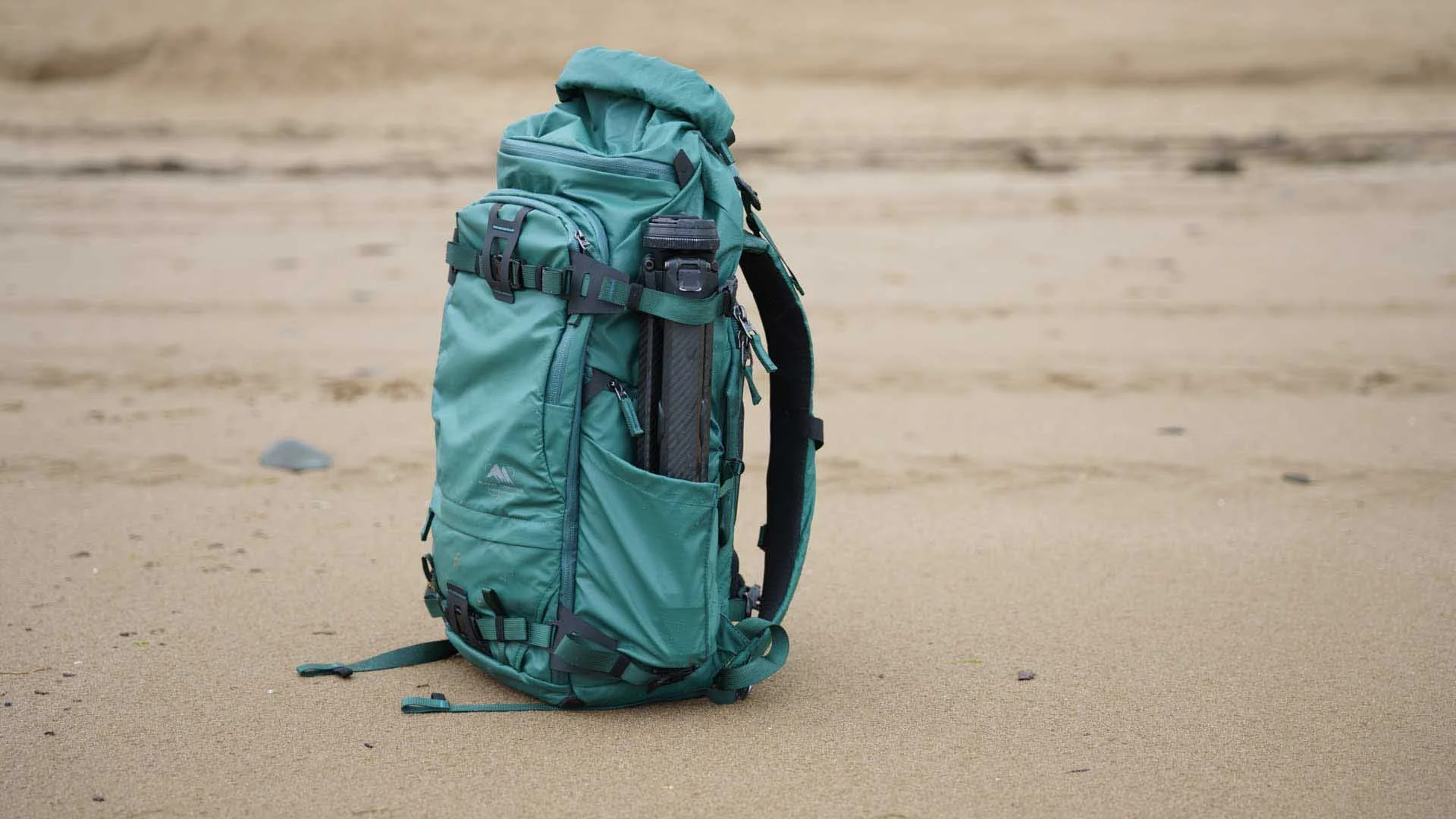  The Summit Creative Tenzing Roll-top 30L backpack has deep side pockets and straps that make it easy to carry a water bottle and a tripod like the Peak Design Travel Tripod shown here. 