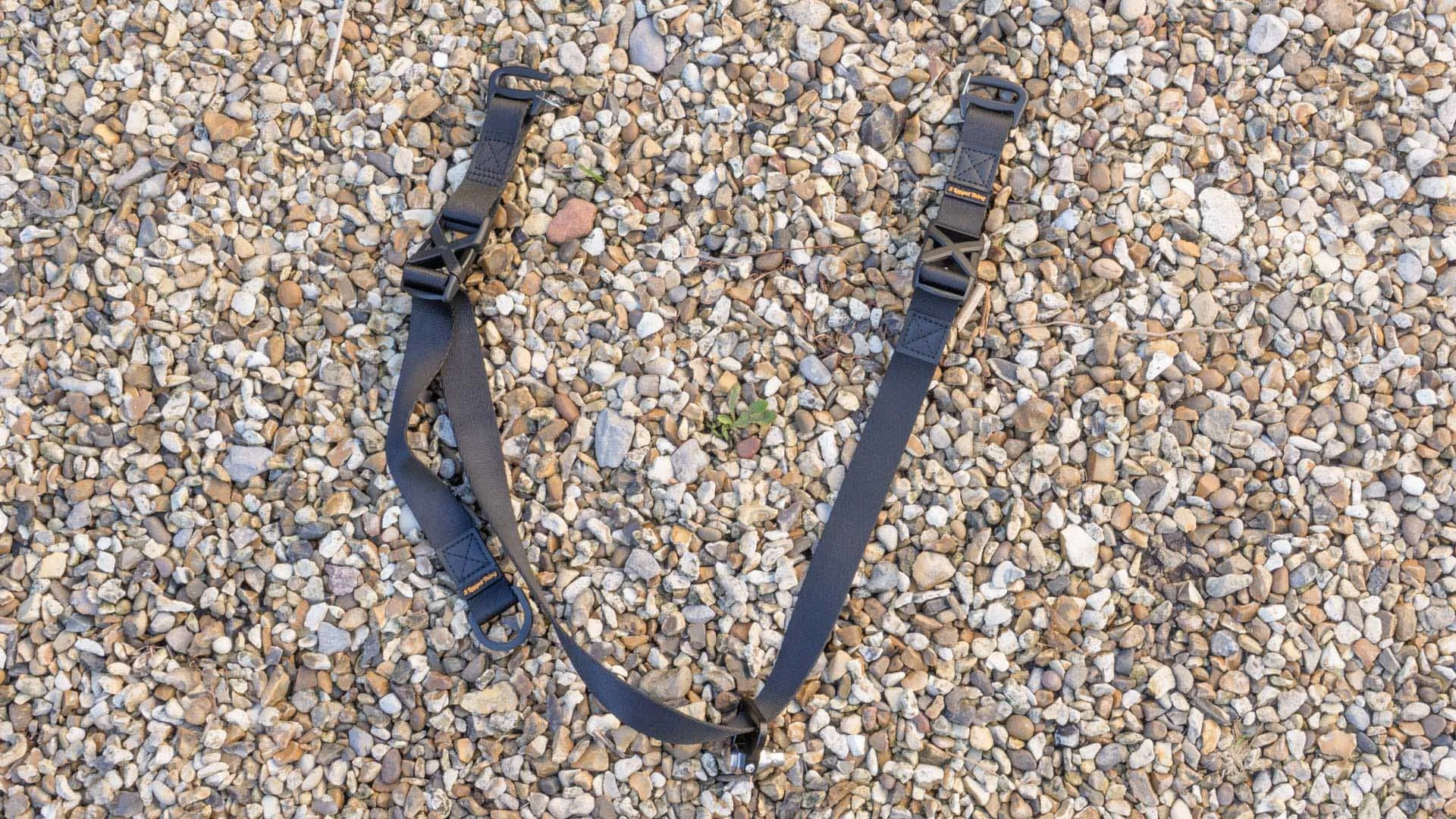 The 3 Legged Thing Axis Anywhere strap lying on gravel