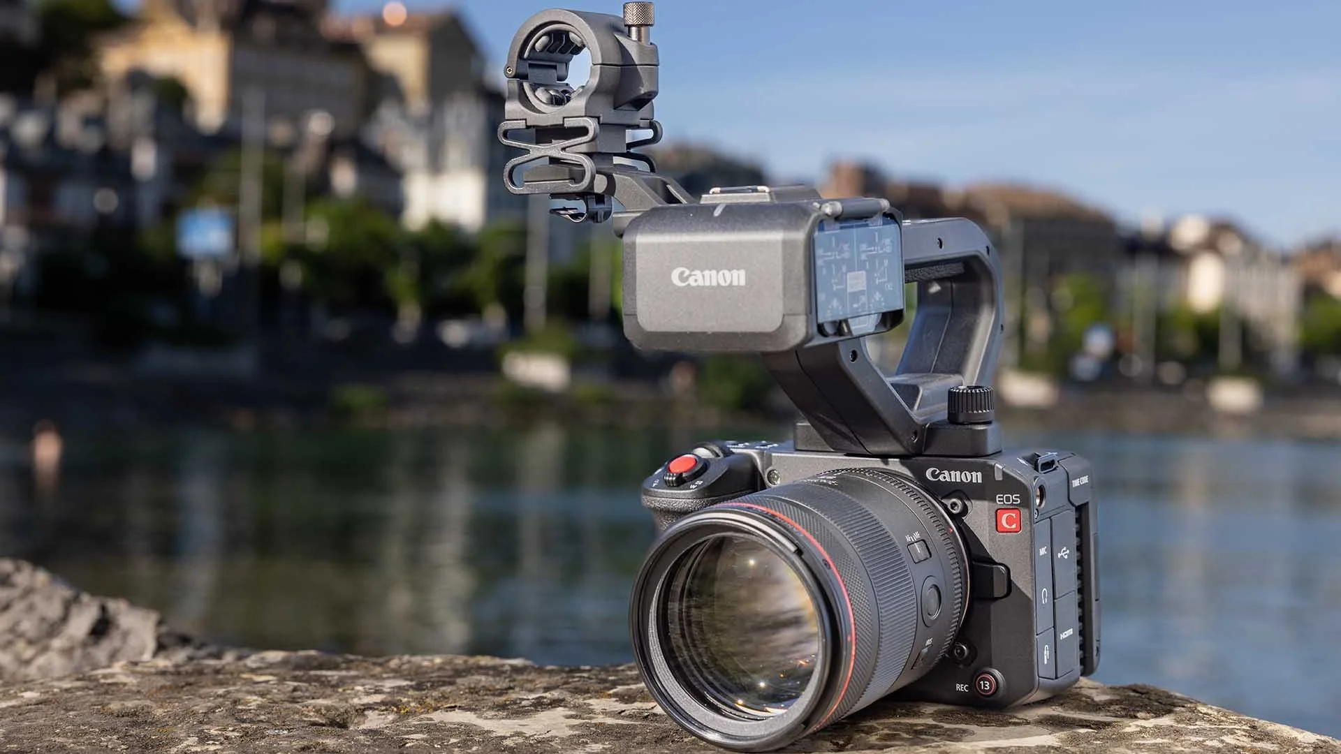 The Canon EOS C50 with its handle attached - on a harbour wall