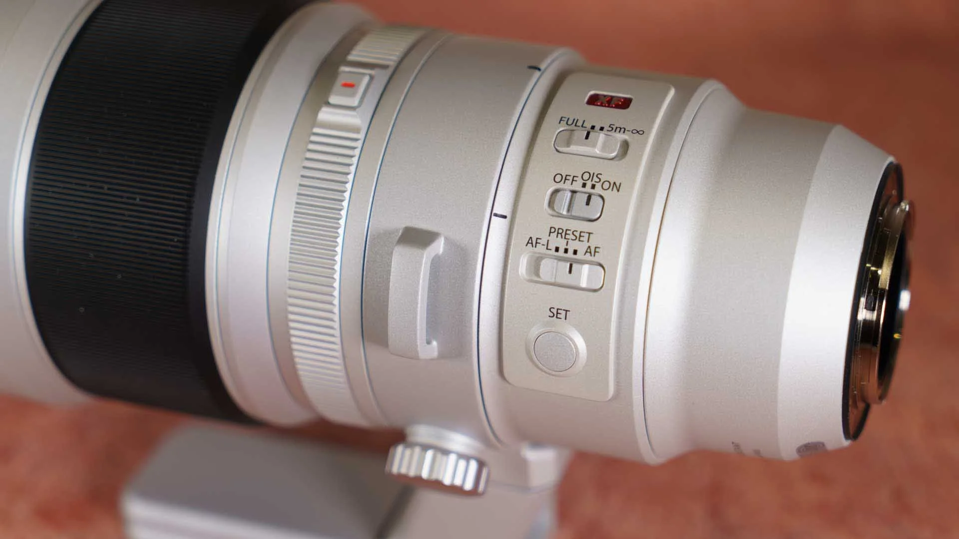  The control switches are within easy reach on the left side of the lens barrel 