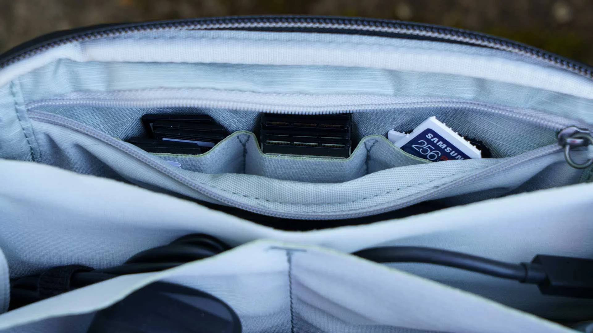  The zippered pocket contains three stretchy pockets that are useful for holding memory cards. 
