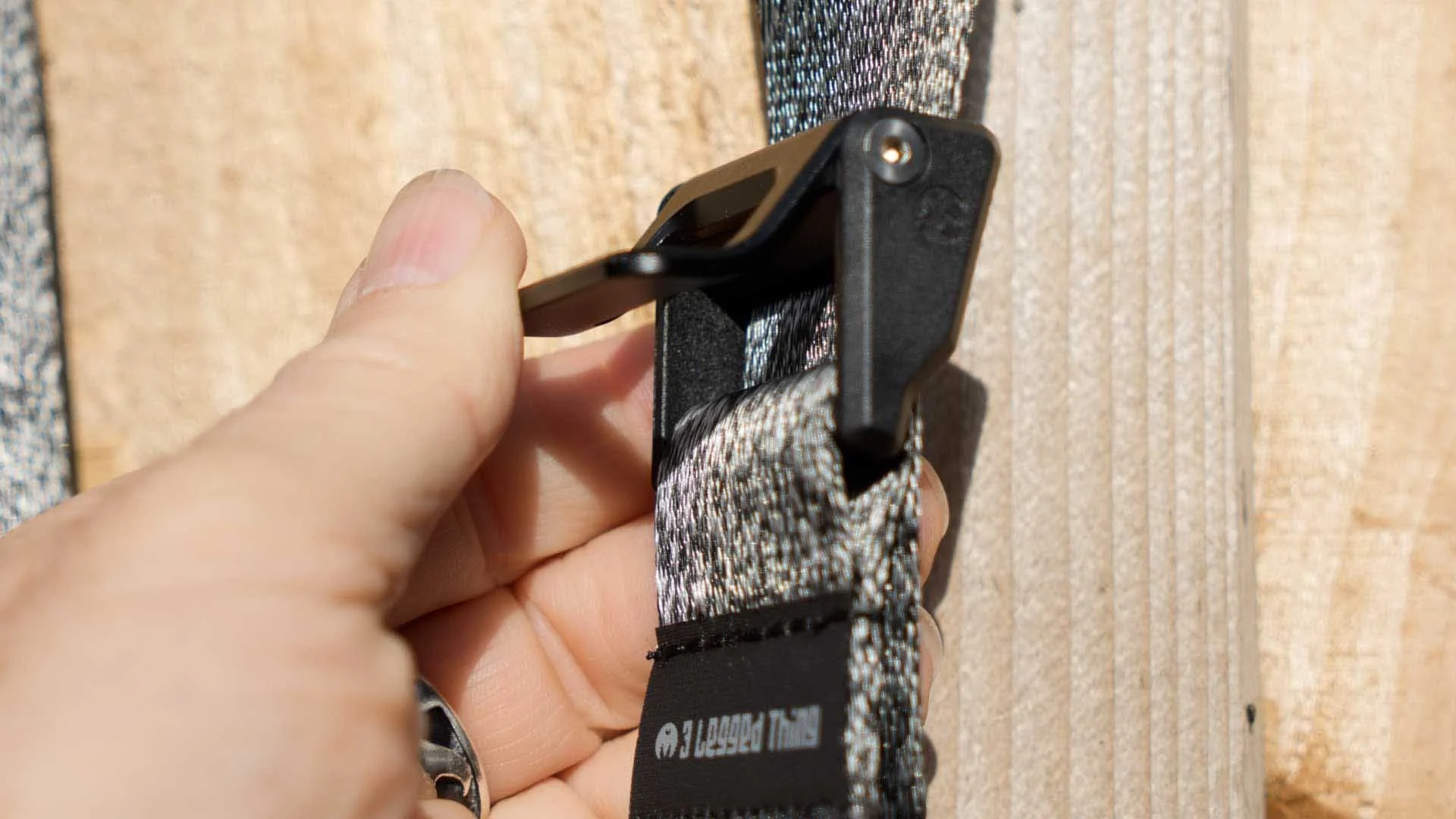 The Axis 34P sliding adjuster being pushed closed by a woman's thumb