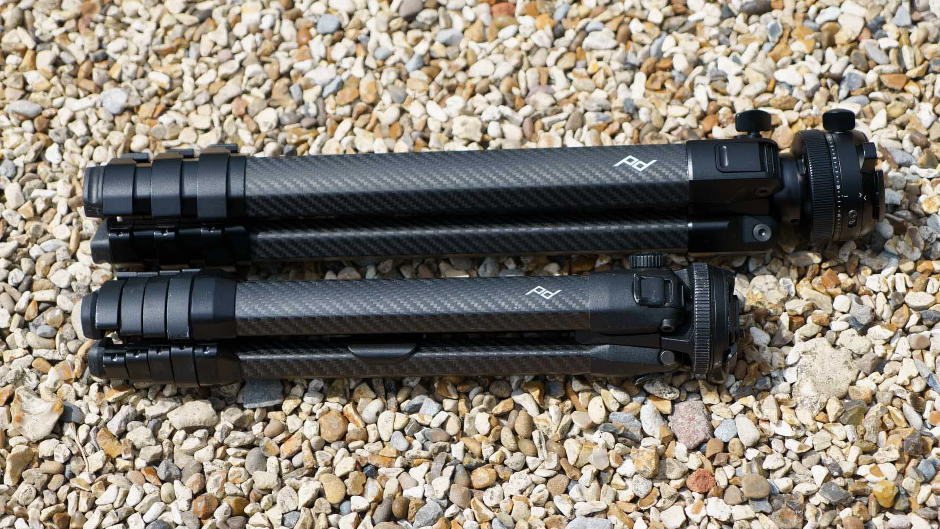  The Peak Design Pro Tripod Lite (top) and Peak Design Travel Tripod (bottom). The Peak Design Pro Tripod Lite is longer and wider than the Travel Tripod when collapsed. It also feels more robust and stable in use. 