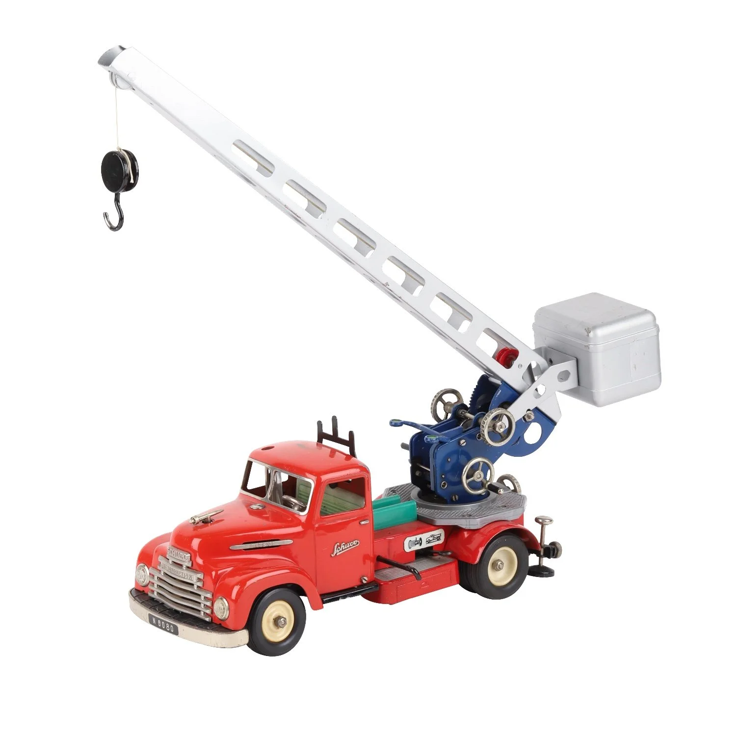 Diecast tinplate 1950s Schuco Elektro 6080 construction fire truck with crane in excellent condition, with three original composition firemen figures, with original box (CA$1,062).