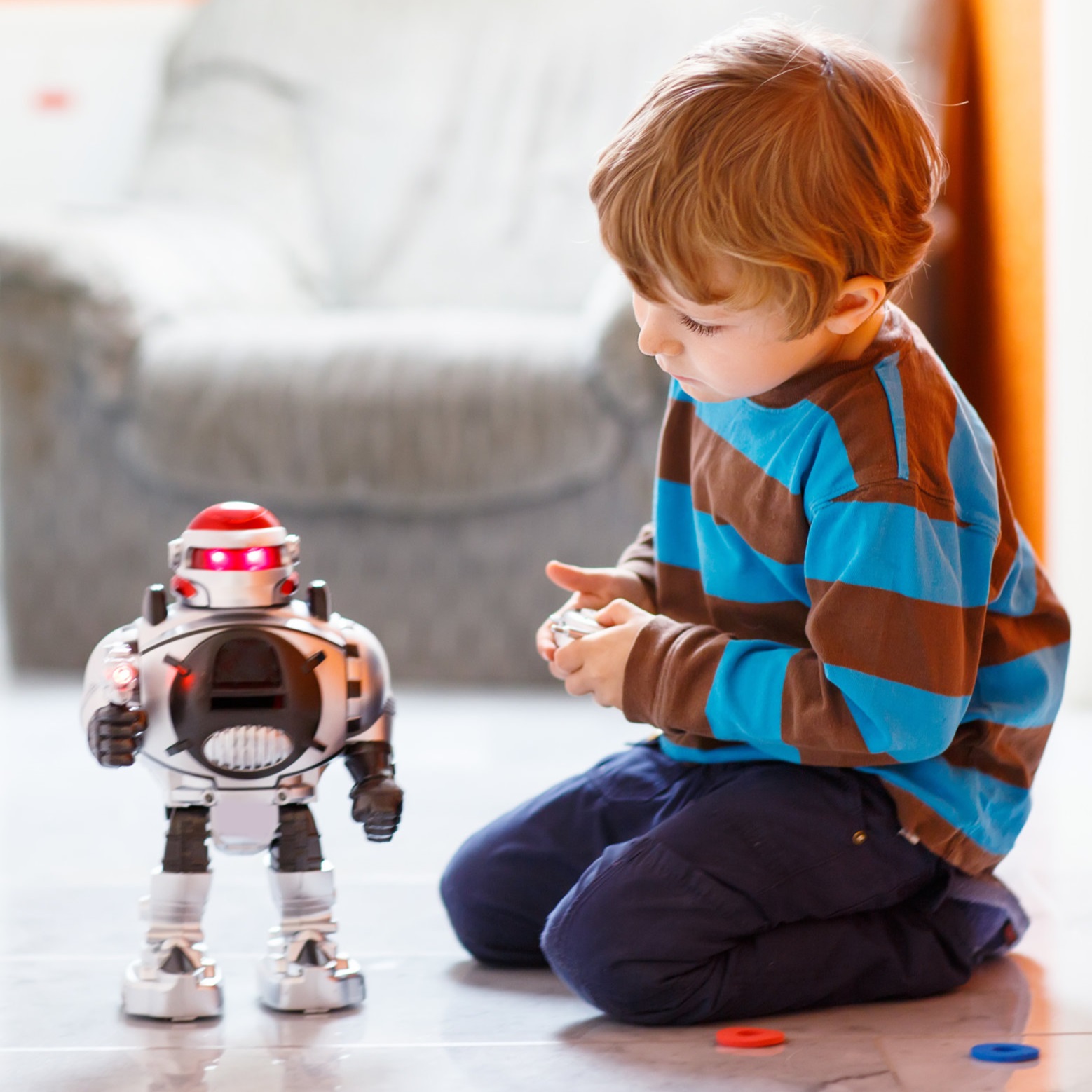 Little boy playing with robot toy