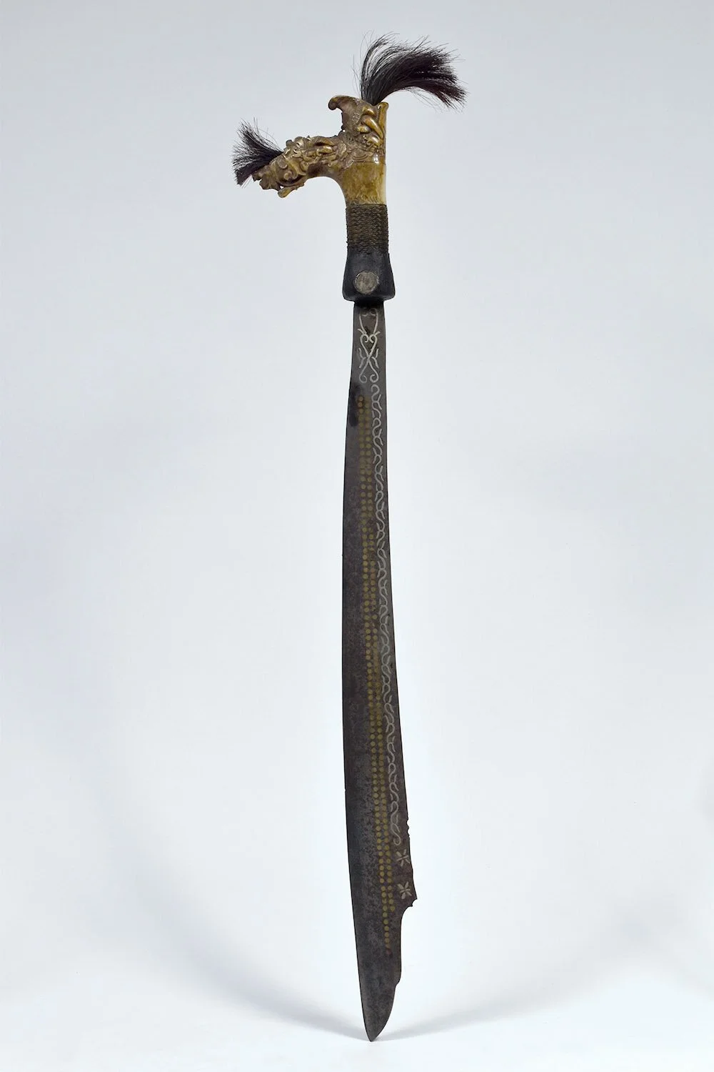 Dayak Mandau Short Sword from Borneo, Indonesia. Deer antler, horse hair, steel, silver, brass, wood, rattan, glass beads, bone, cotton, woven fishing line, resin, silver coins