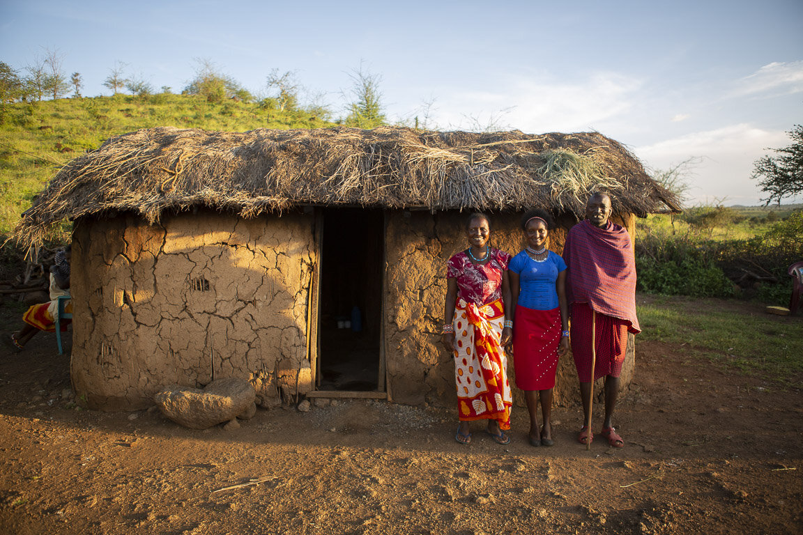 Faith Moinan Peter_with mom and dad and home_horizontal_Smaller_.JPG