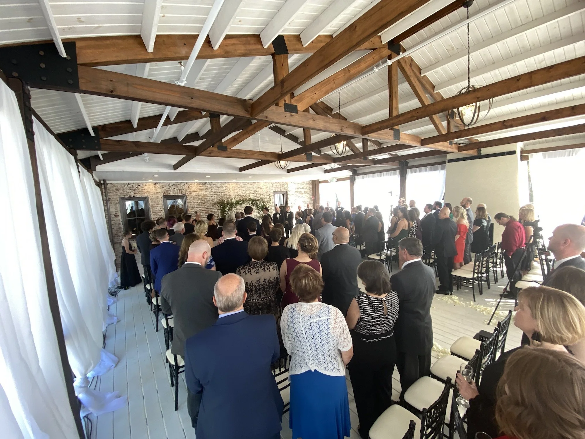 A wedding ceremony at the Cowan Historic Mill, outdoors on the covered terrace.