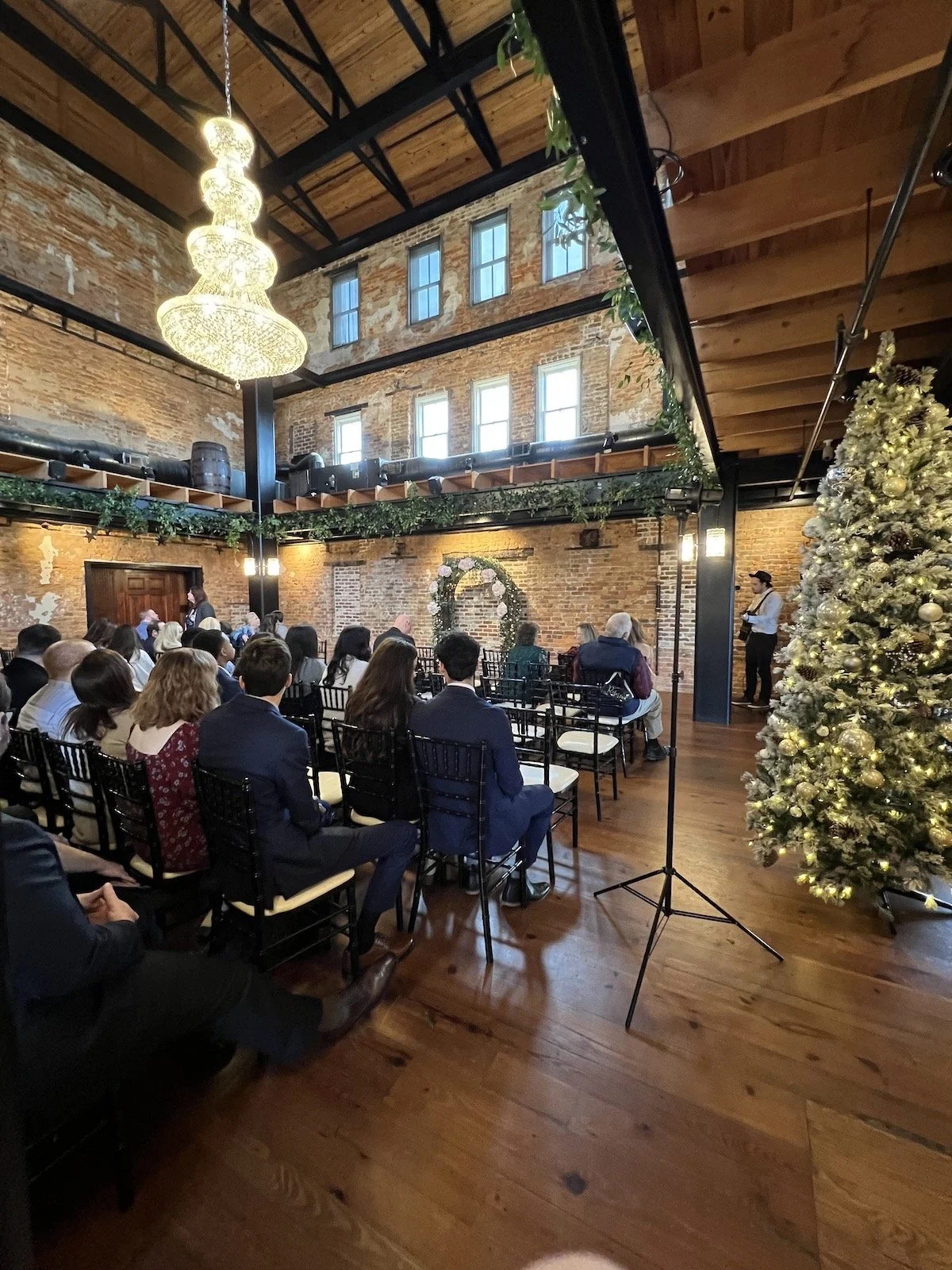 A wedding ceremony at The Cowan Historic Mill, indoors in the ballroom.