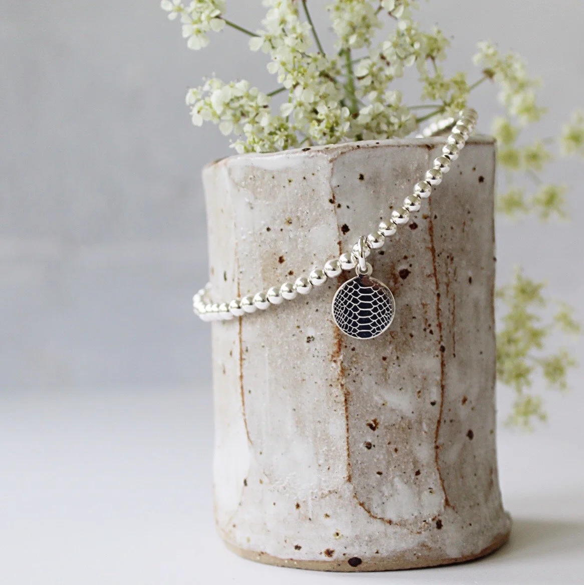 Silver snakeskin print charm bracelet