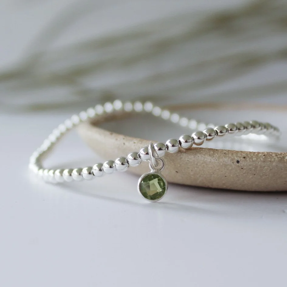 Silver stacking bracelet with Peridot charm.JPG