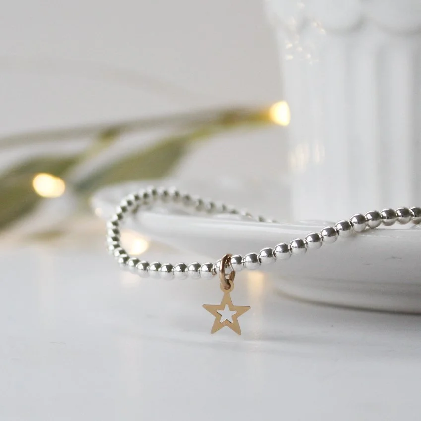 Silver stretchy stacking bracelet with gold filled star