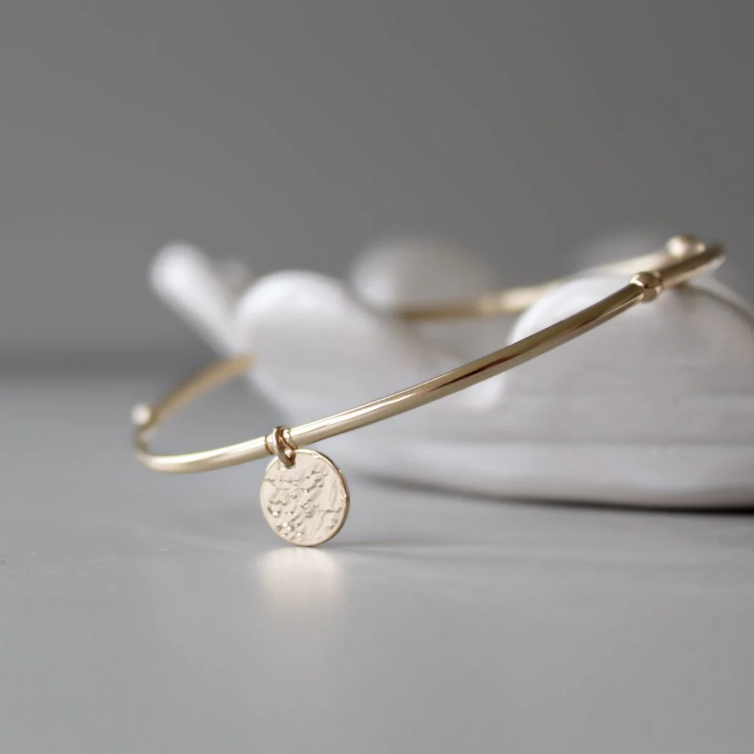 Gold stacking bracelet with hammered disc