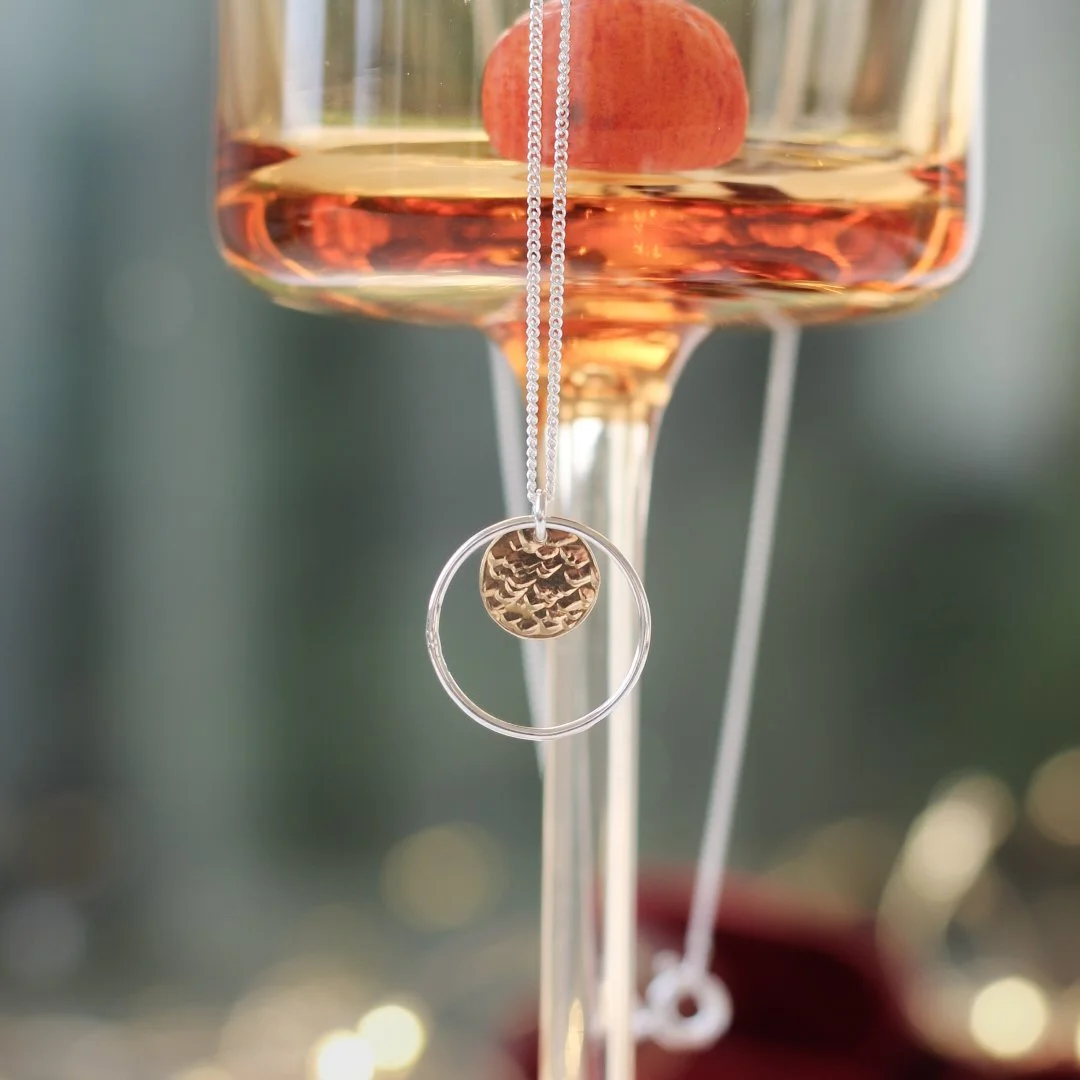 Silver halo necklace with gold hammered disc