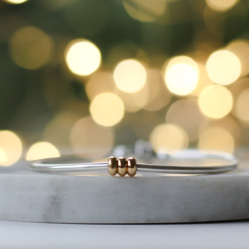 Silver bracelet with 3 gold chunky rings