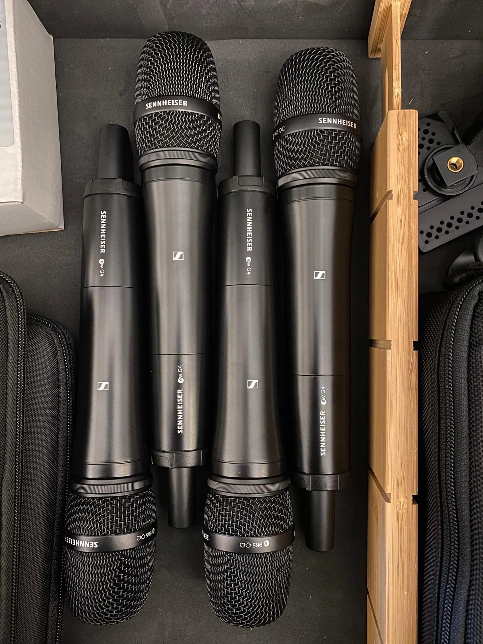 Four Wireless Sennheiser Microphones Laying End to End