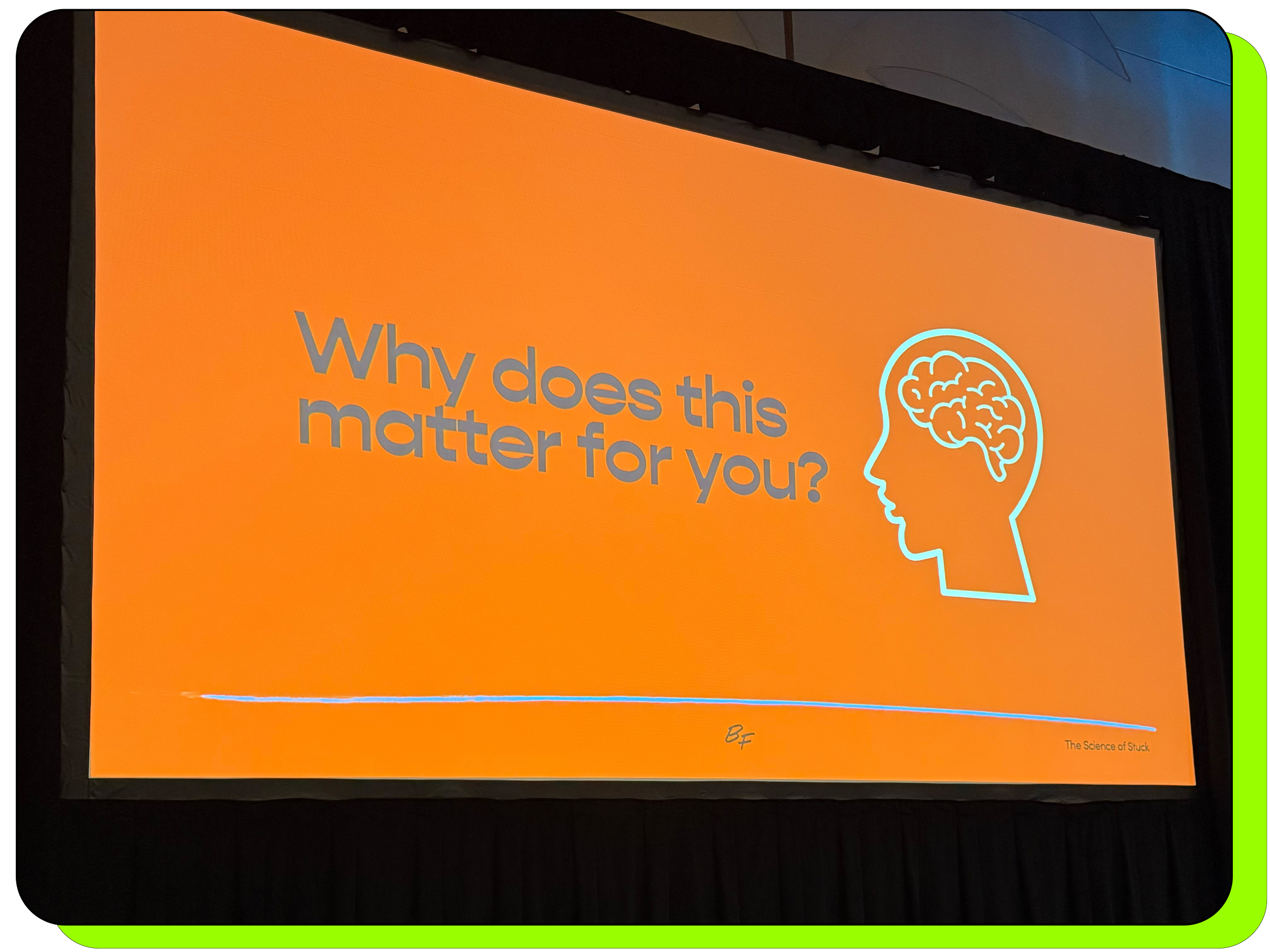 Large projection screen displaying a graphic slide that says "Why does this matter for you?" and shows an illustration of a human face with a brain hand drawn