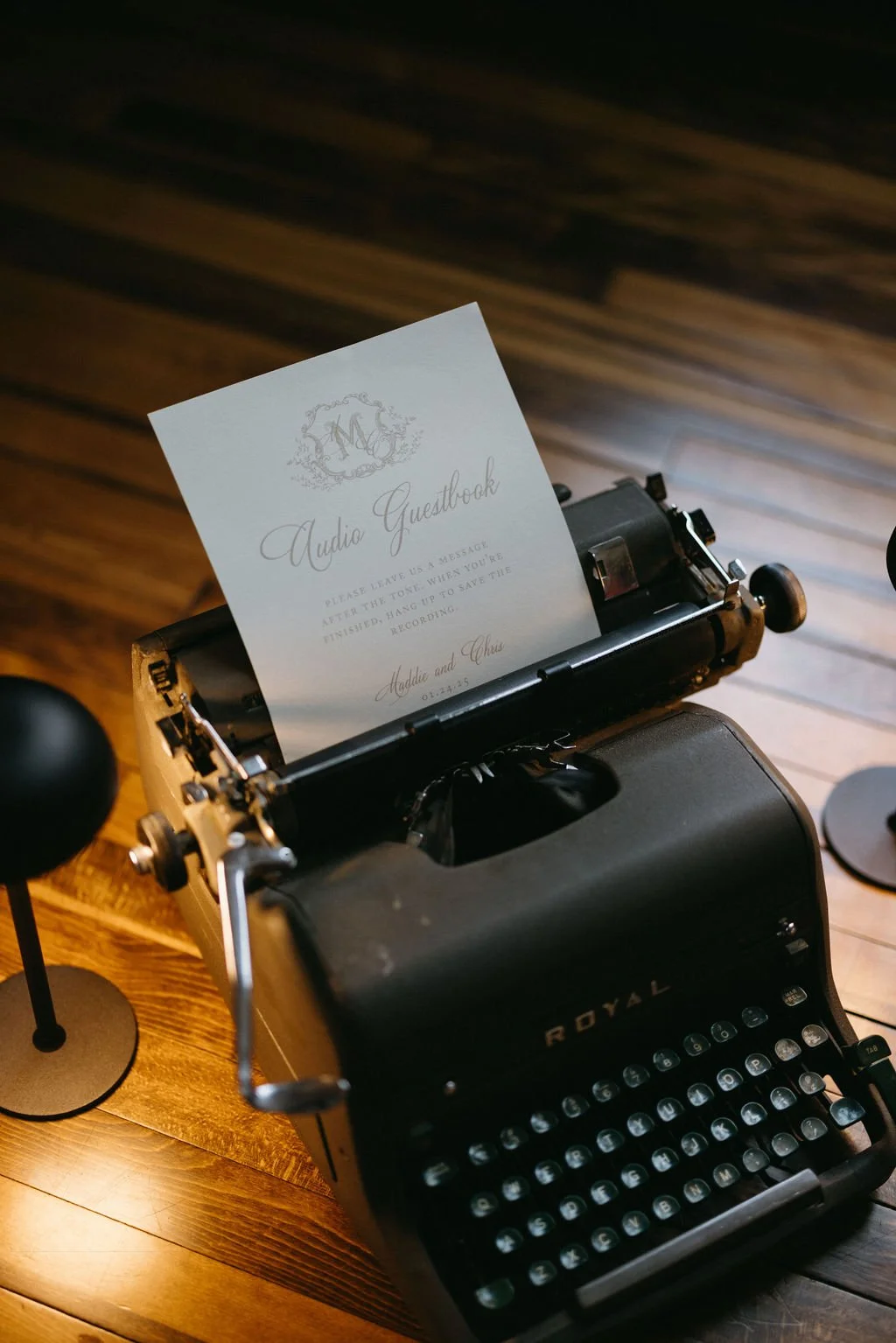 Nostalgic black vintage typewriter displayed with custom wedding paper stationery and warm lighting.