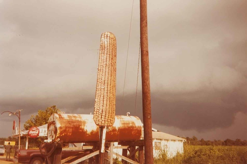   Corn Sign with Storm Cloud, Near Greensboro, Alabama , 1977 Dye Coupler Color Print 3 1/4 x 4 3/4 in. (image size) The Do Good Fund, Inc., 2016-116 