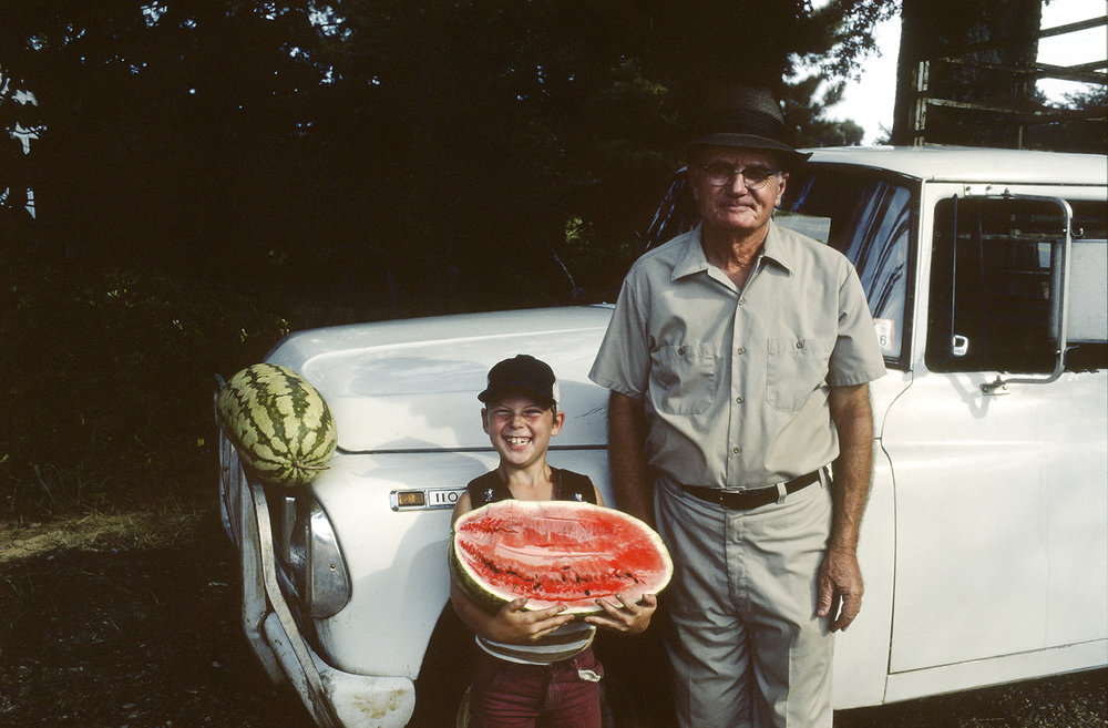   Unidentified watermelon vendor and son, Betcheimer Store, Highway 27, Utica, Mississippi , 1974 13 × 20 in. (image size) The Do Good Fund, Inc., 2016-139 