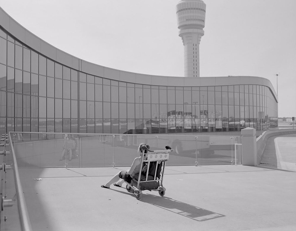   Untitled (woman on luggage cart, Atlanta airport)   Silver Gelatin Print 15 1/8 × 20 15/16 in. (image size) The Do Good Fund, Inc., 2018-052 