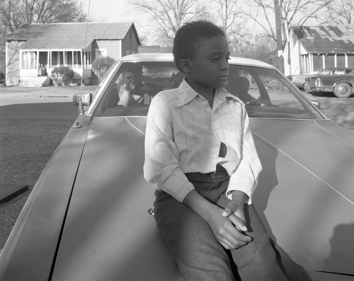   Child on Hood, Hughes, AR , 1984 Archival pigment print  15 × 19 in. (image size) The Do Good Fund, Inc., 2016-24 
