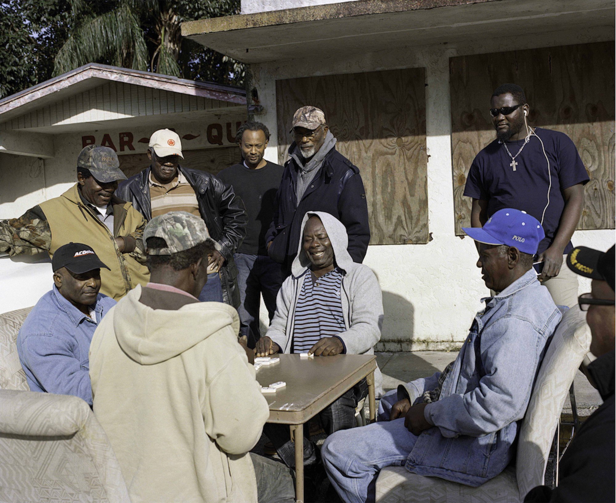   Men Playing Domino During the Day in Downtown Belle Glade, 2016   Archival Pigment Print  16x19 1/2 (image size)  The Do Good Fund, Inc., 2025-006 
