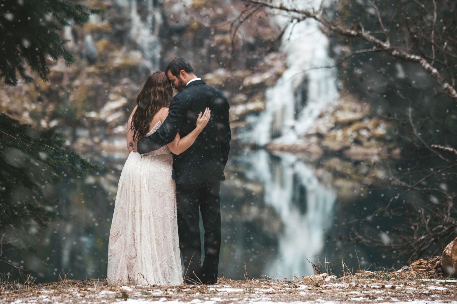 couple-embrace-snow-river-north-cascades