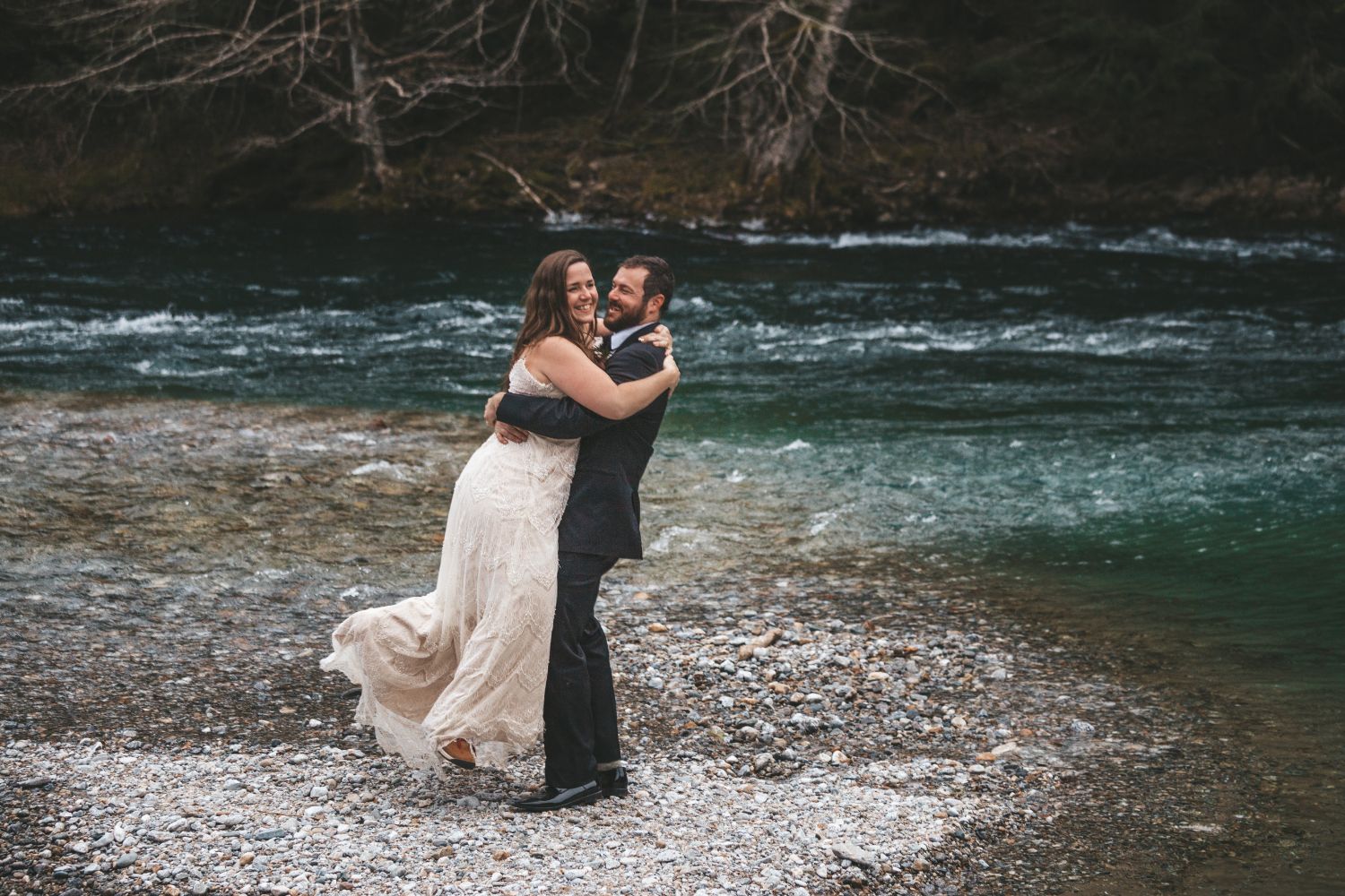 groom-lifts-bride-beautiful-river-north-cascade-winter-wedding