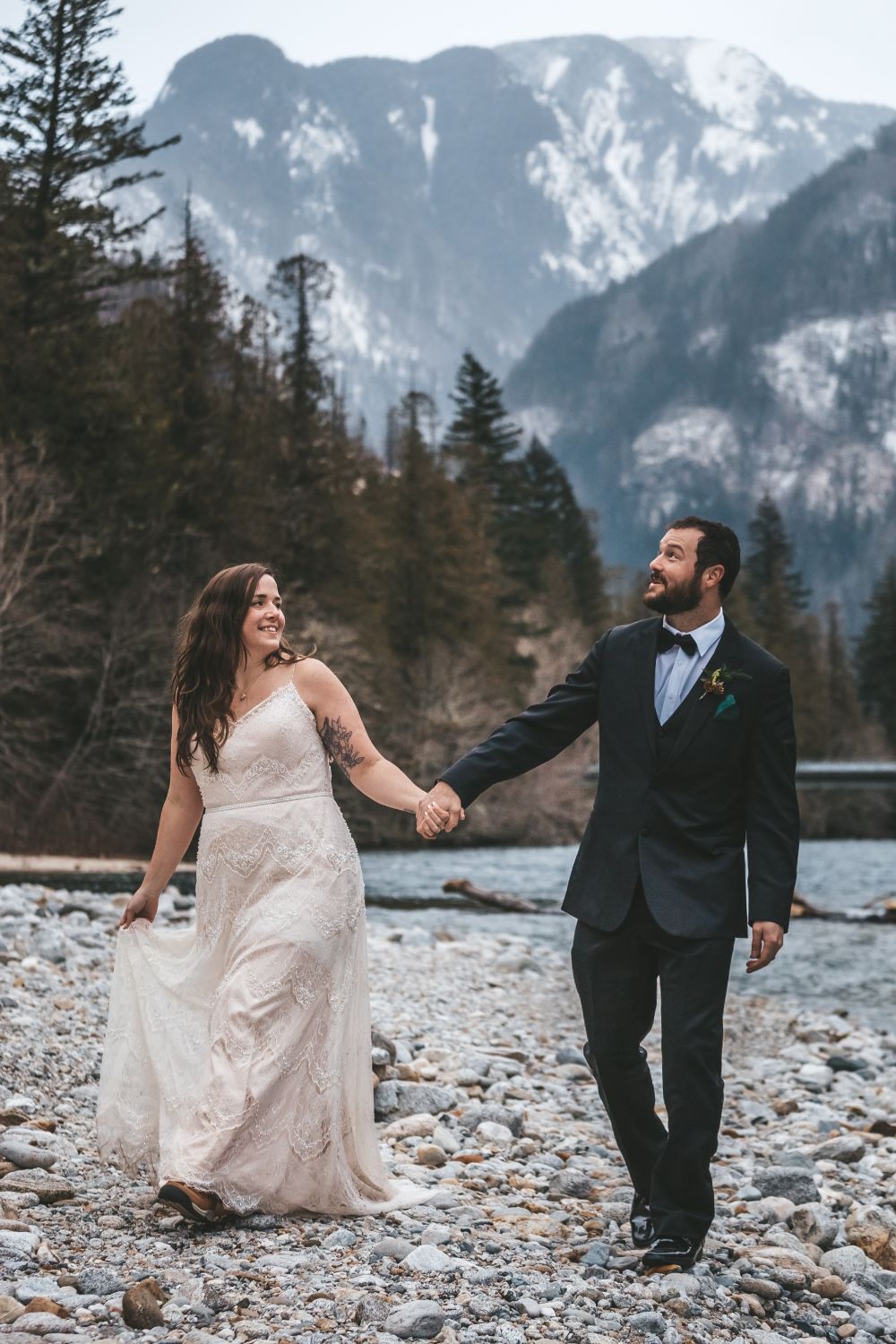 couple-walking-holding-hands-snowy-mountain