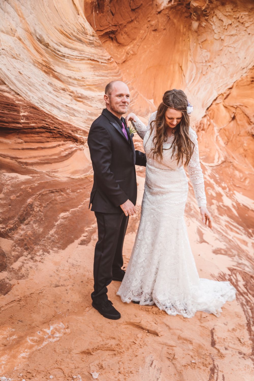 groom-bride-walk-desert-sandstone