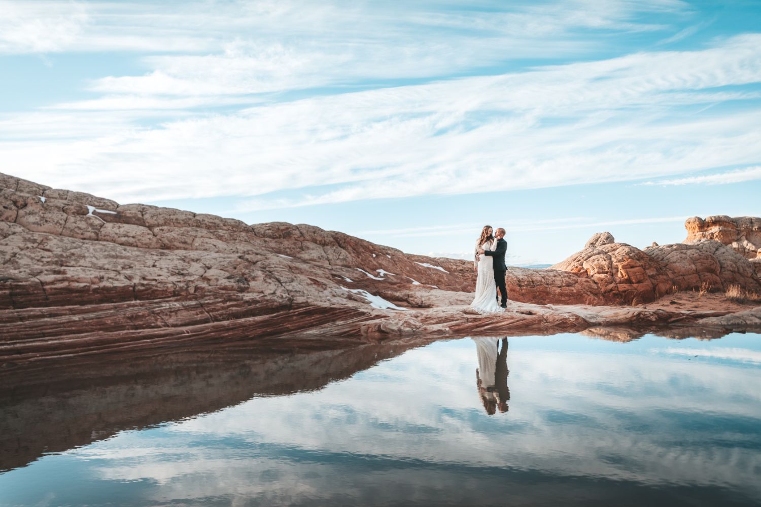 bride-kisses-groom-water-pool-utah-desert