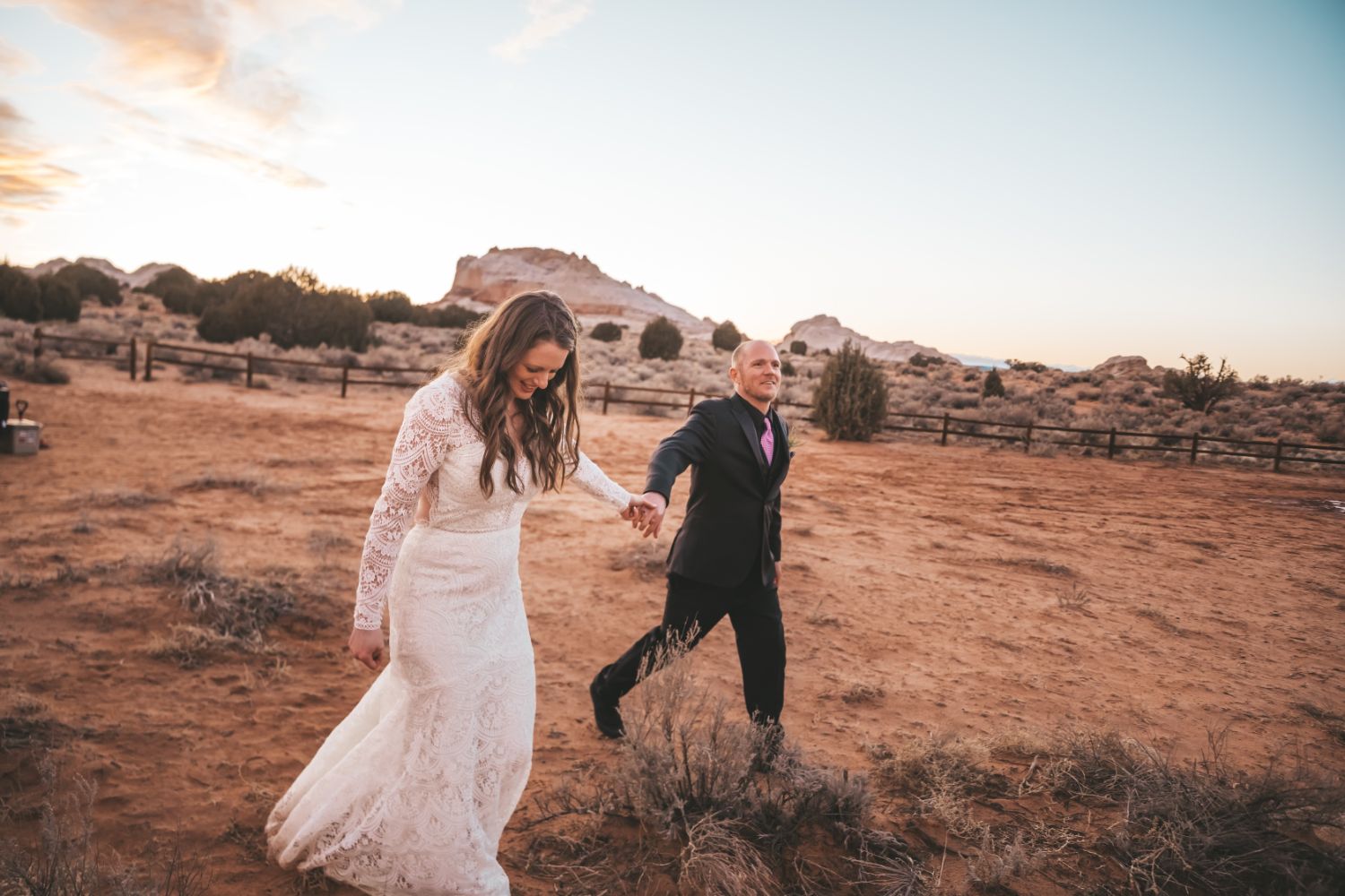 bride-groom-hold-hands-sunset-utah-desert