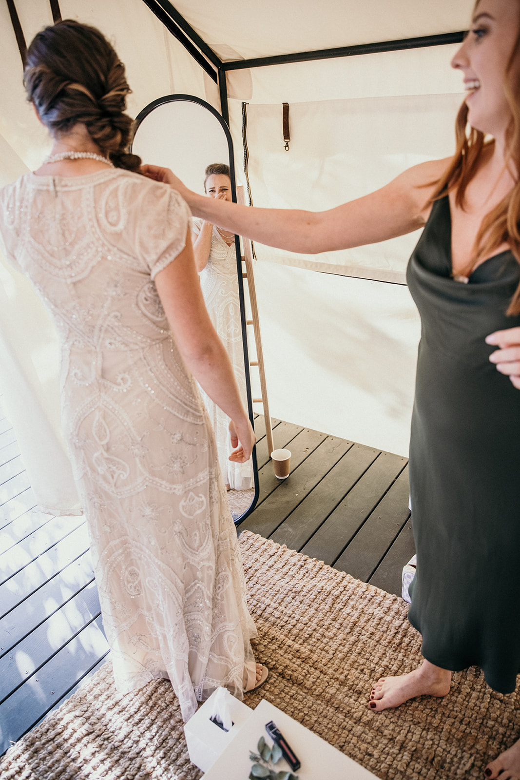  The bride becomes emotional when she sees her hair and makeup and her dress on at the same time.  
