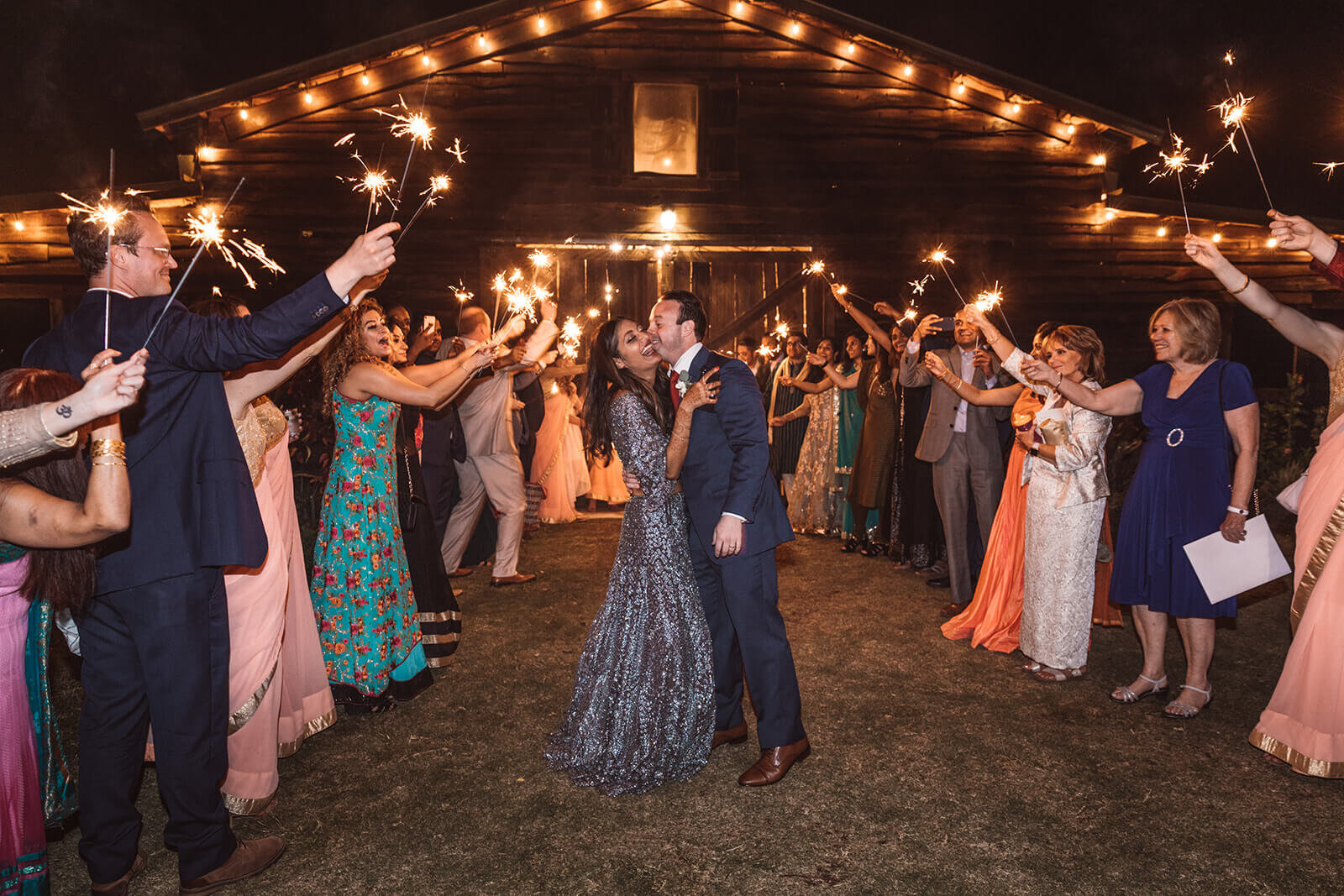  The bride and groom embrace during their sparkler exit 