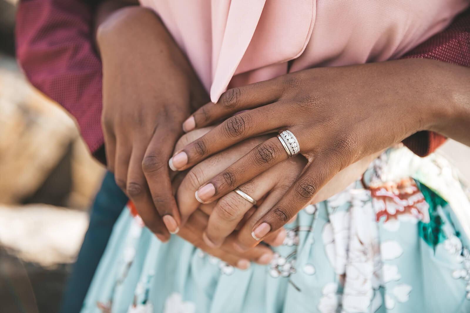  Hands with wedding bands at Castle Hill Lighthouse 