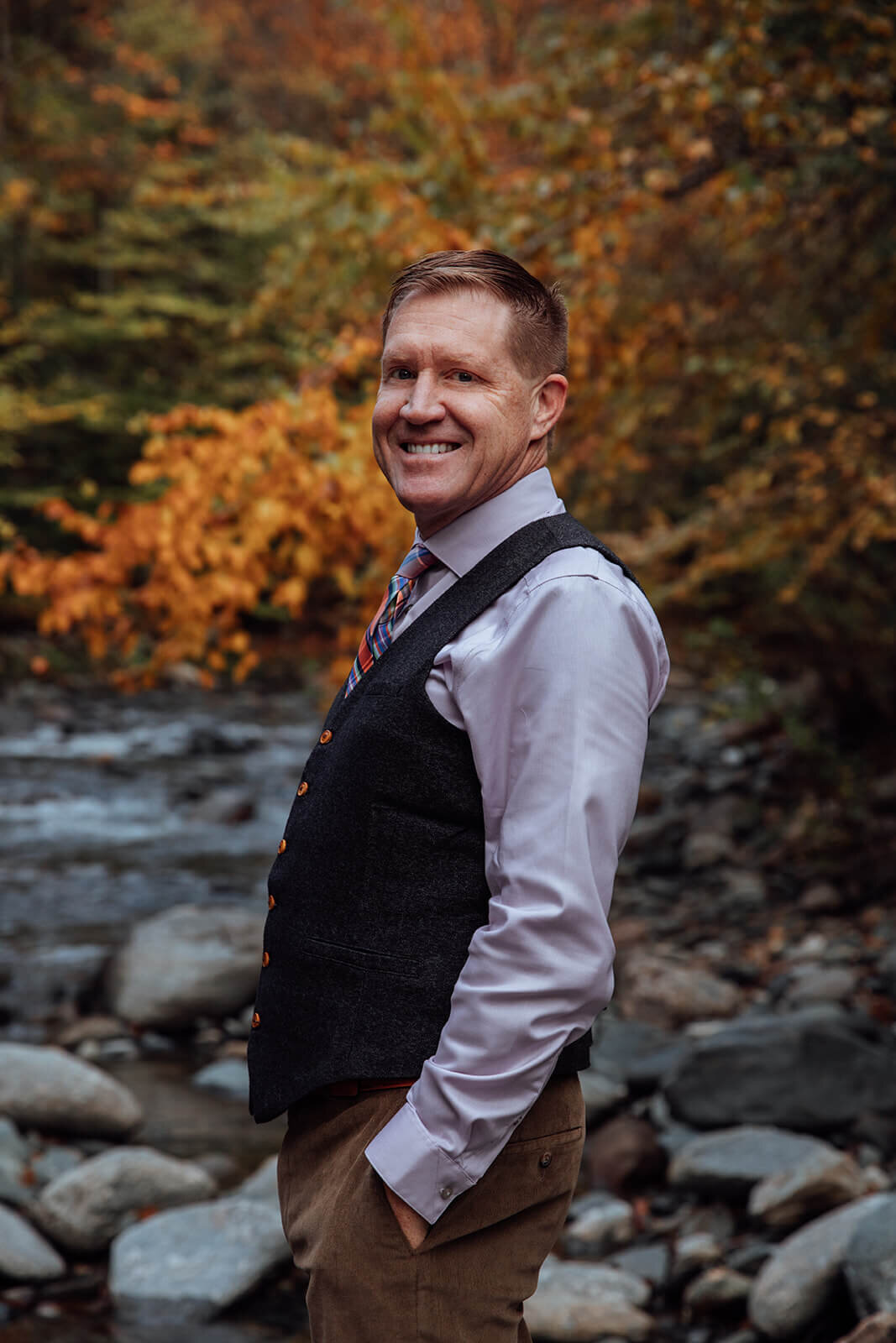  Groom checks out the surrounding area by his cabin and finds a stream surrounded with fall colors 