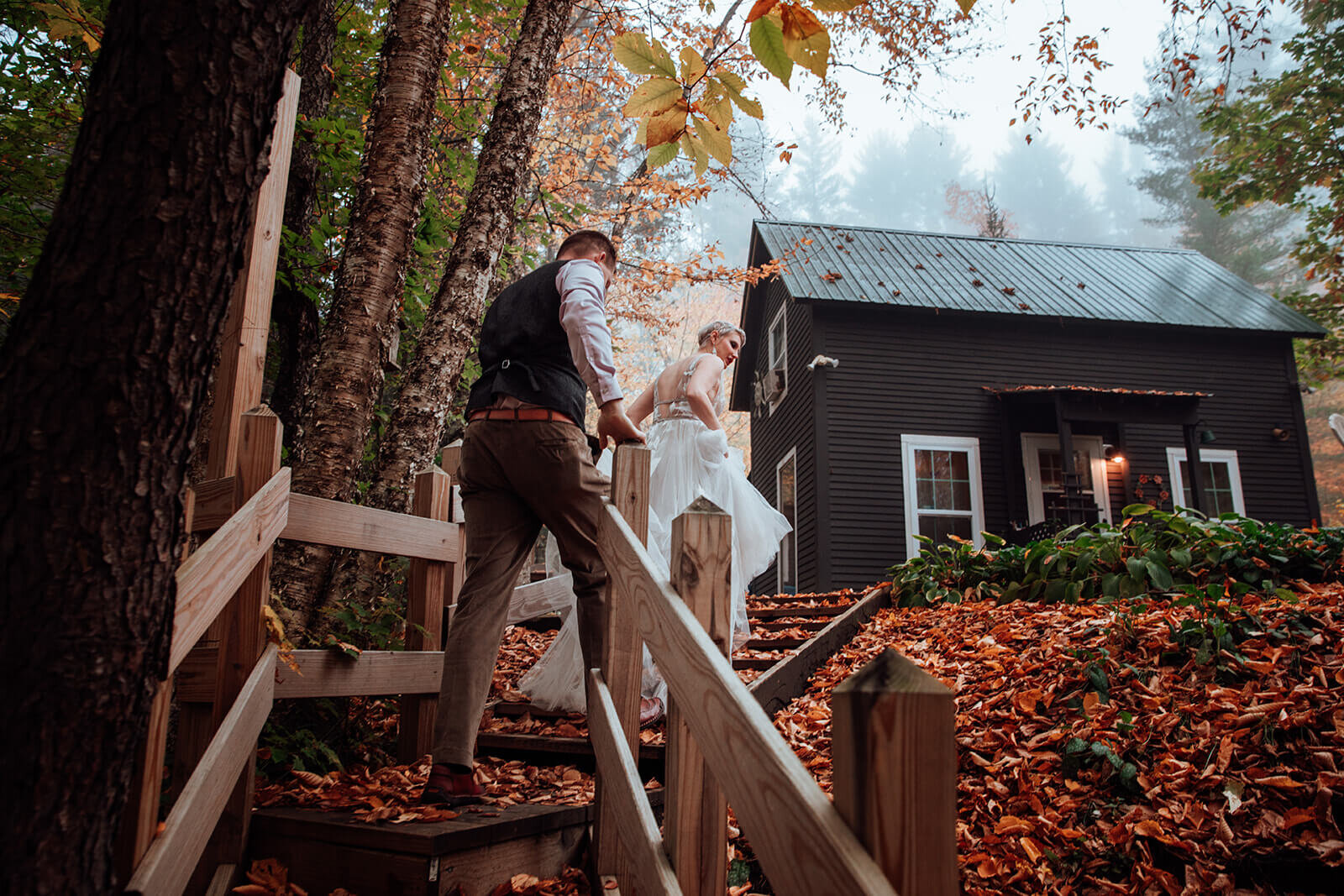  Eloping couple head back up the staircase toward their ceremony site during peak fall colors in Vermont 