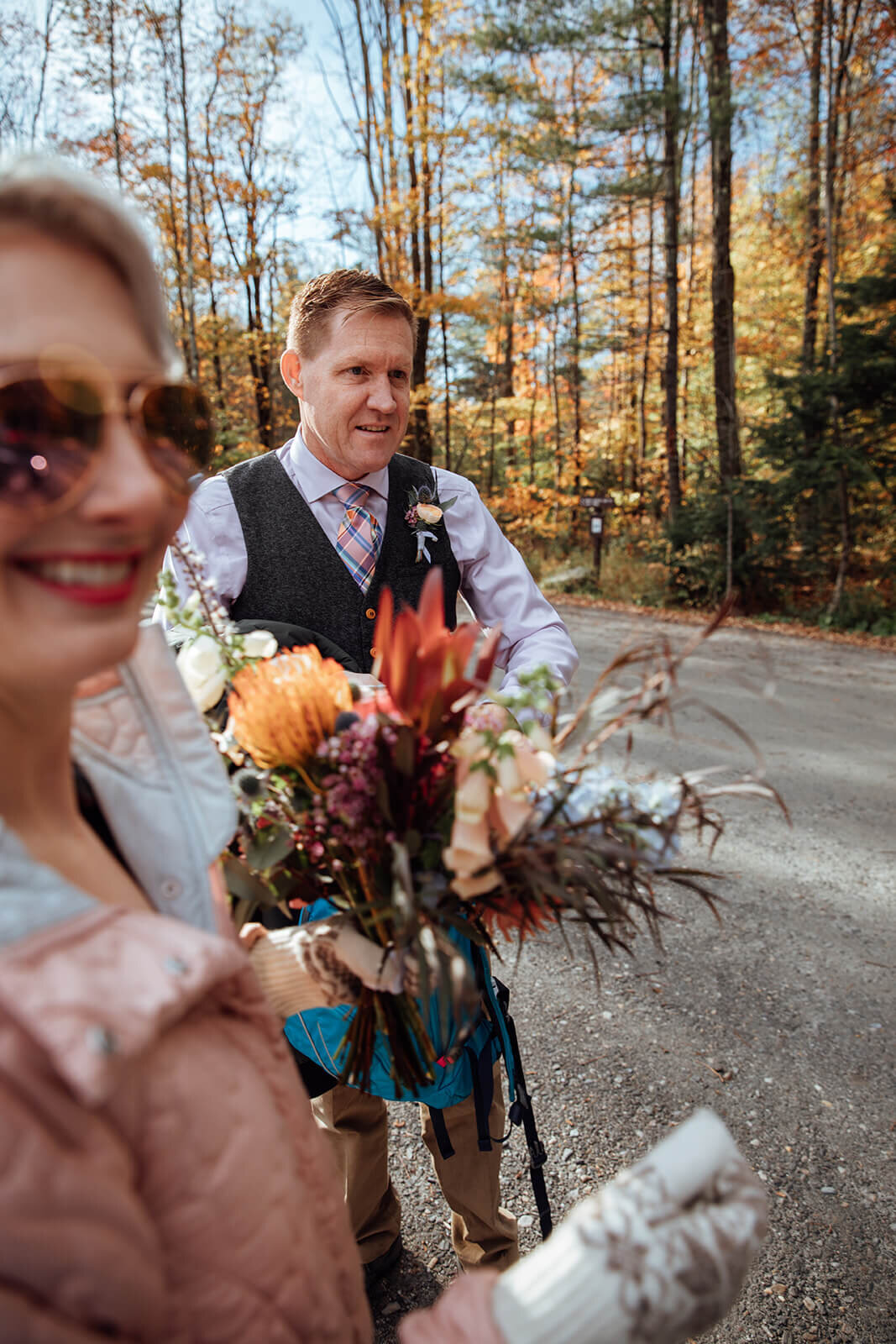  Bride and groom wave to people as they are congratulated about their elopement in Vermont 