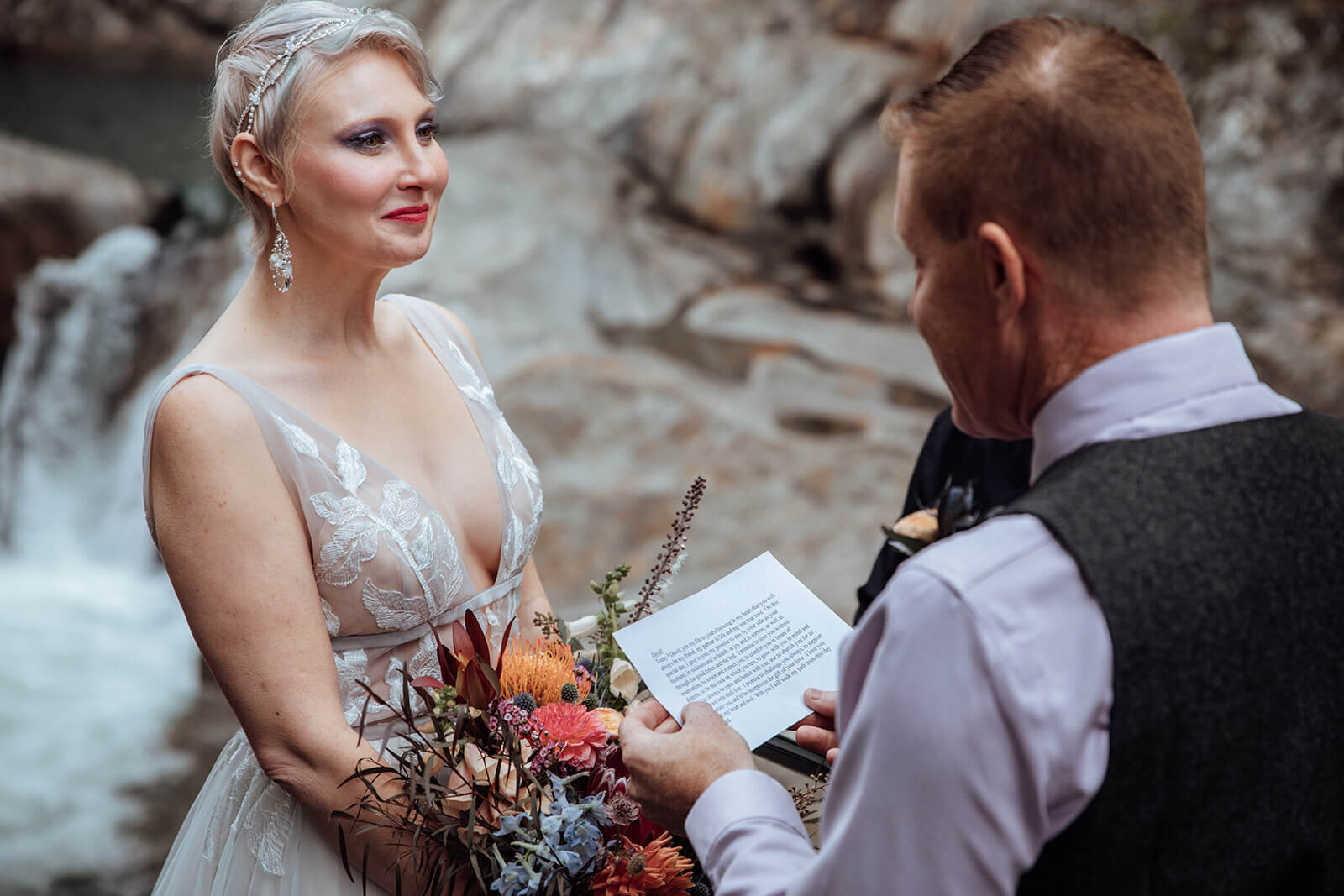  Bride reacts to grooms vows at Warren Falls, VT 