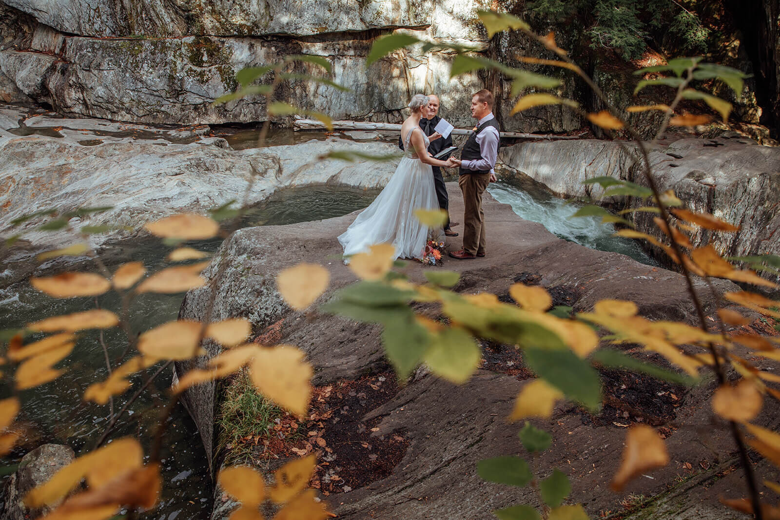  Bride reads her vows to the groom during elopement ceremony at Warren Falls in Vermont 