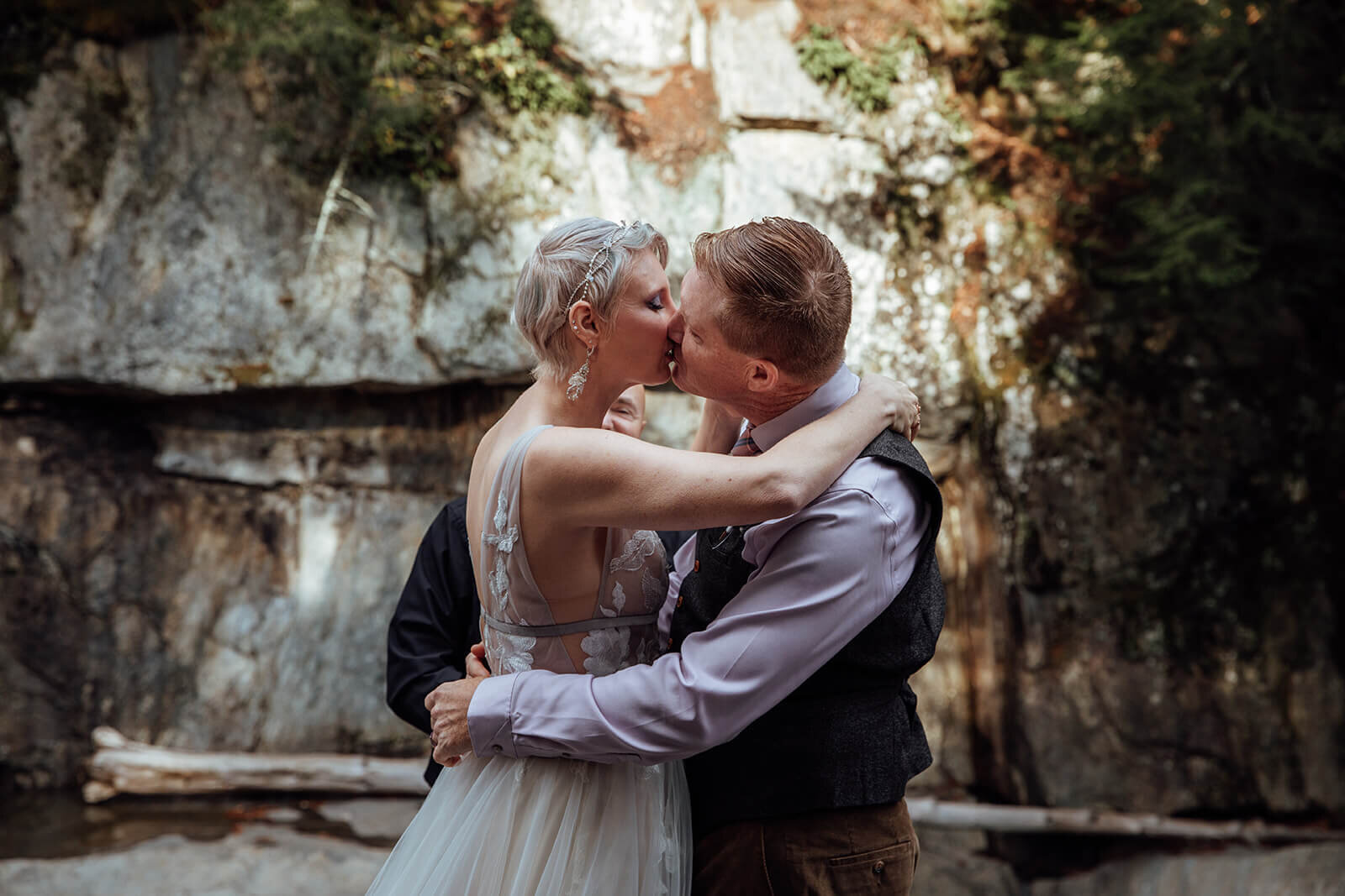  Couple shares first kiss as married couple during their elopement ceremony at Warren Falls in Vermont 