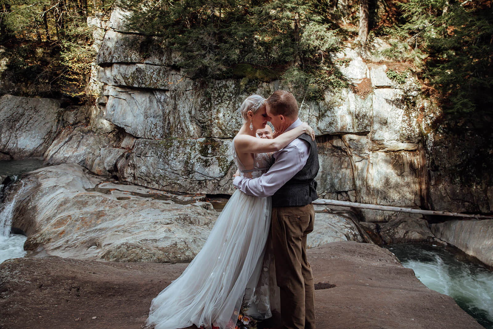  Couple shares intimate moment as married couple during their elopement ceremony at Warren Falls in Vermont 