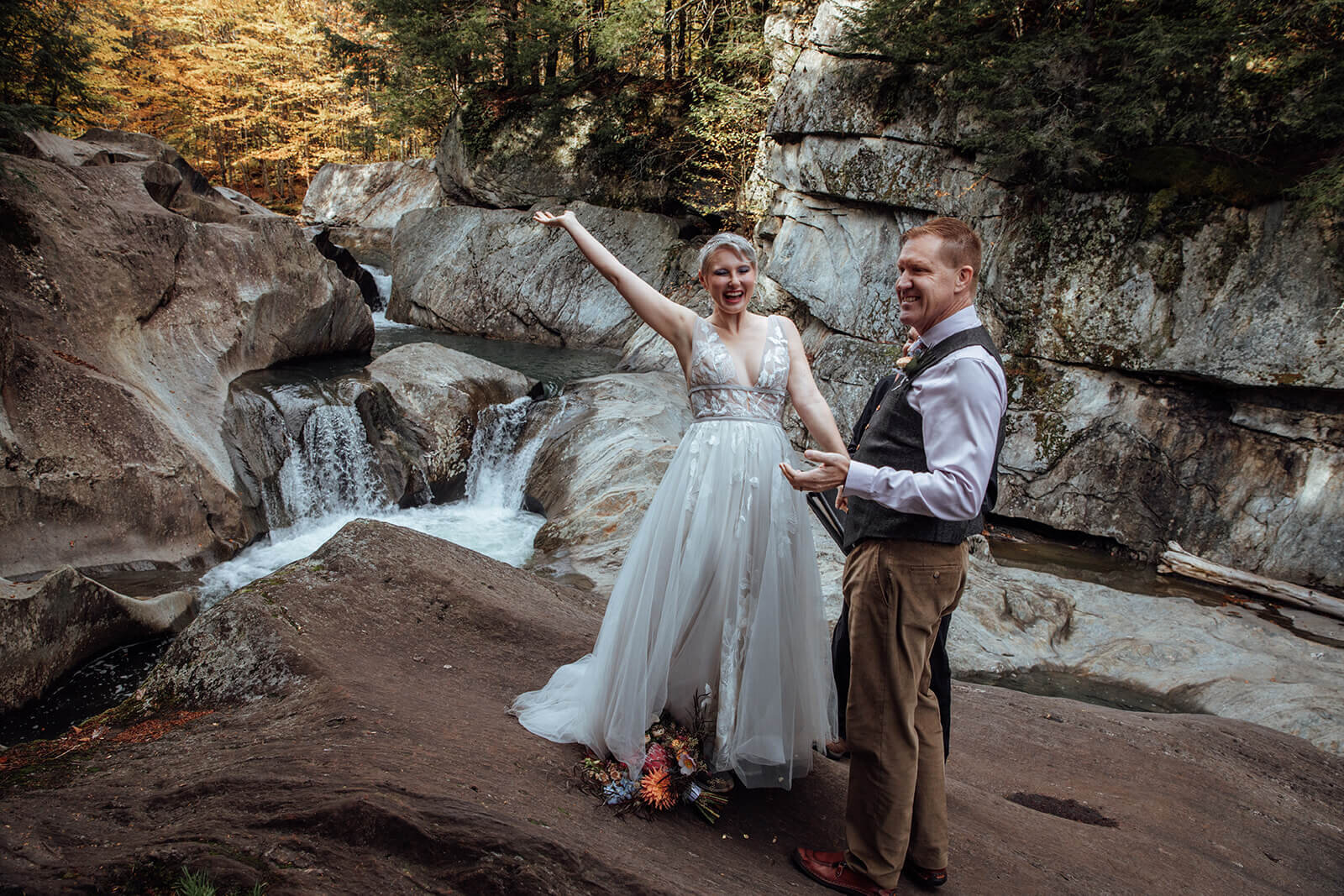  Couple celebrates as married couple during their elopement ceremony at Warren Falls in Vermont 