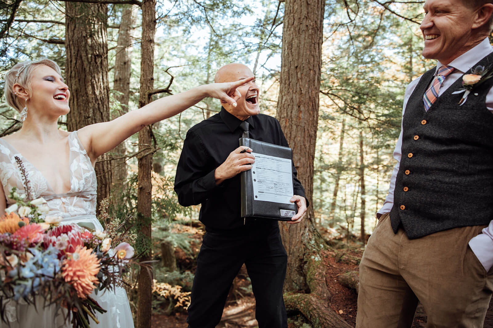  Bride laughs at groom because now he is stuck with her after their elopement at Warren Falls in Vermont 