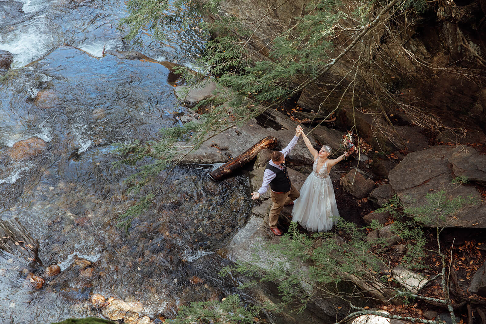  Bride and groom check out the Mad River after eloping at Warren Falls in Vermont 