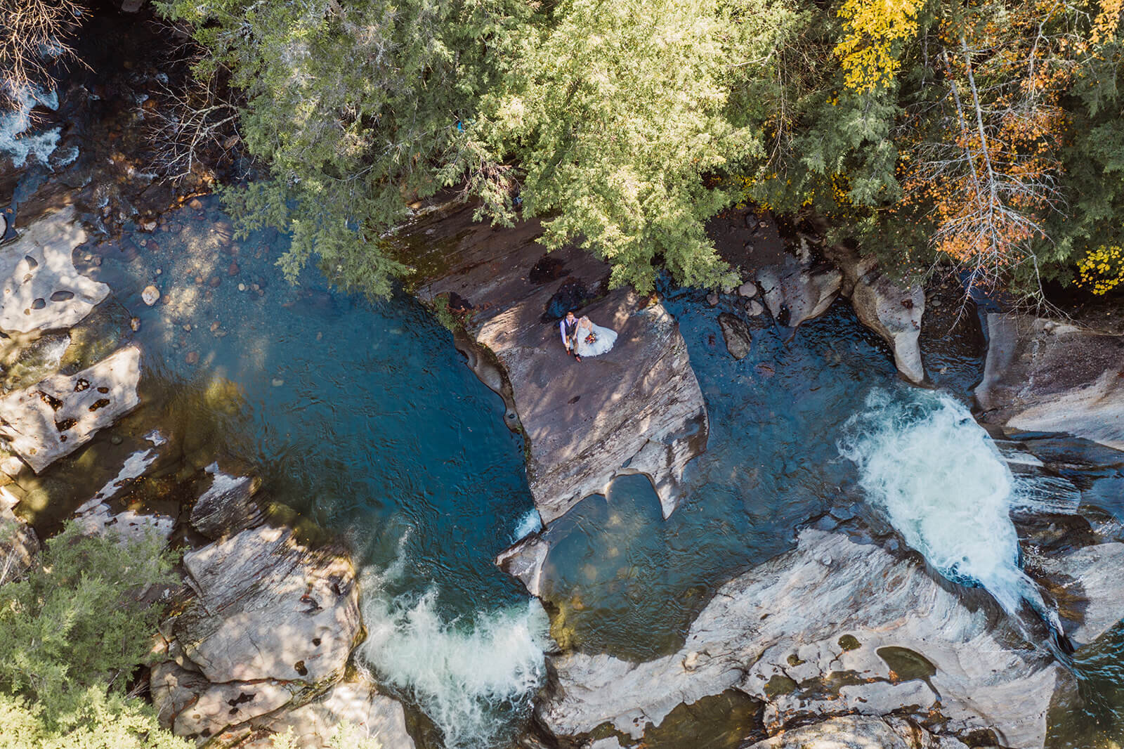  Drone shot of Bride and groom on cliff at Warren Falls, VT after eloping. 