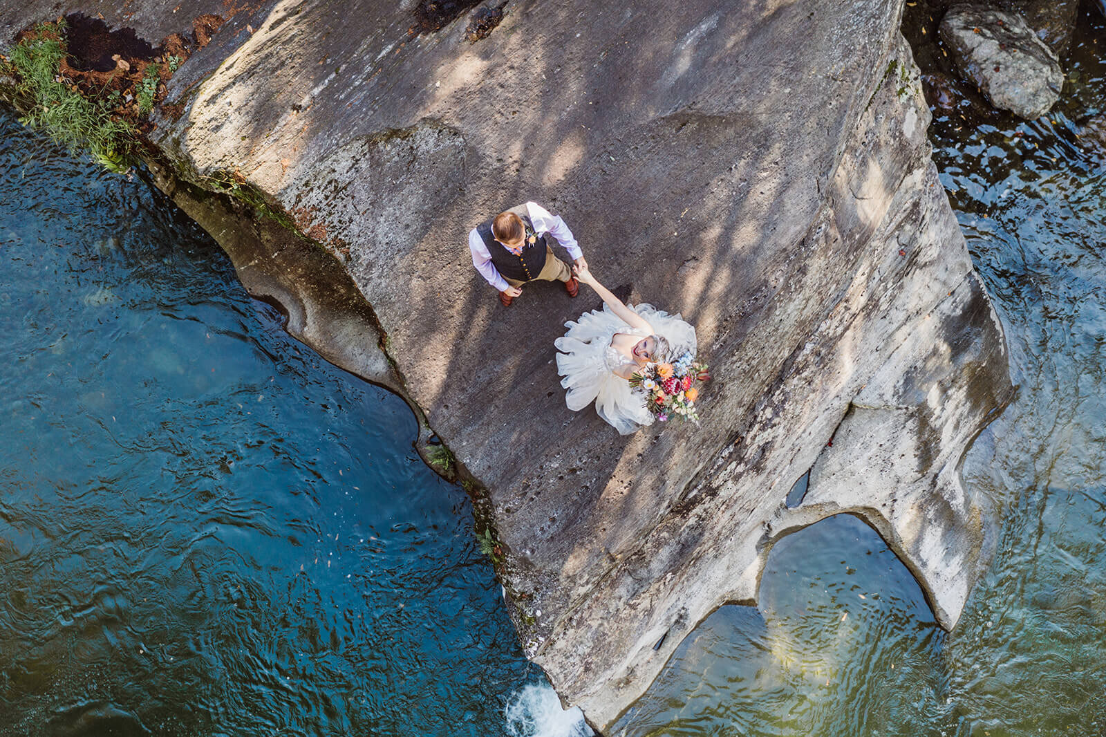  Drone shot of Bride and groom on cliff at Warren Falls, VT after eloping. 