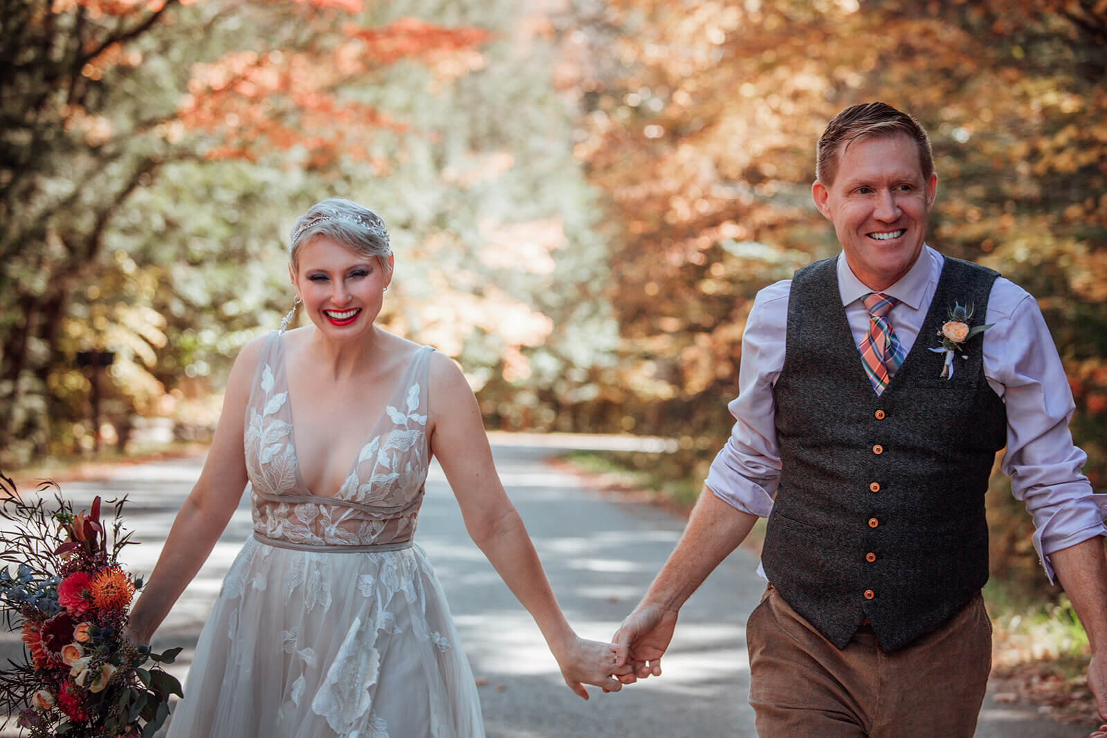 Couple runs through colorful tree tunnel after their elopement in Vermont 